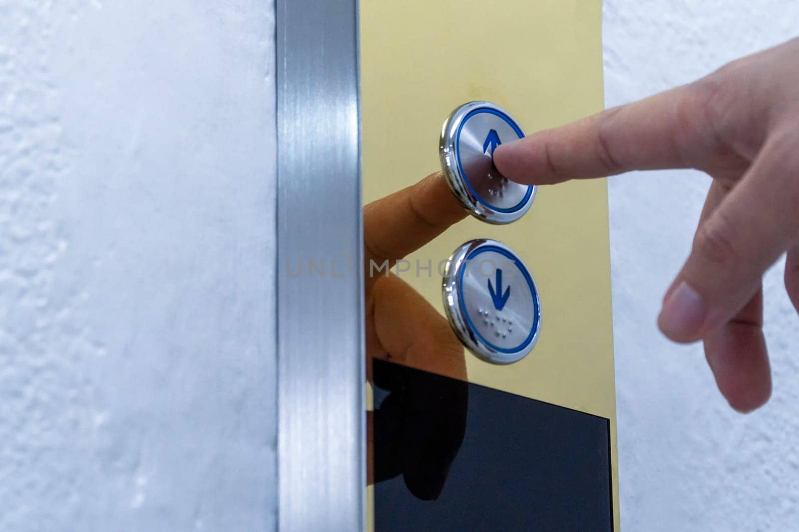 Using hands, press the elevator up and keypad elevator
