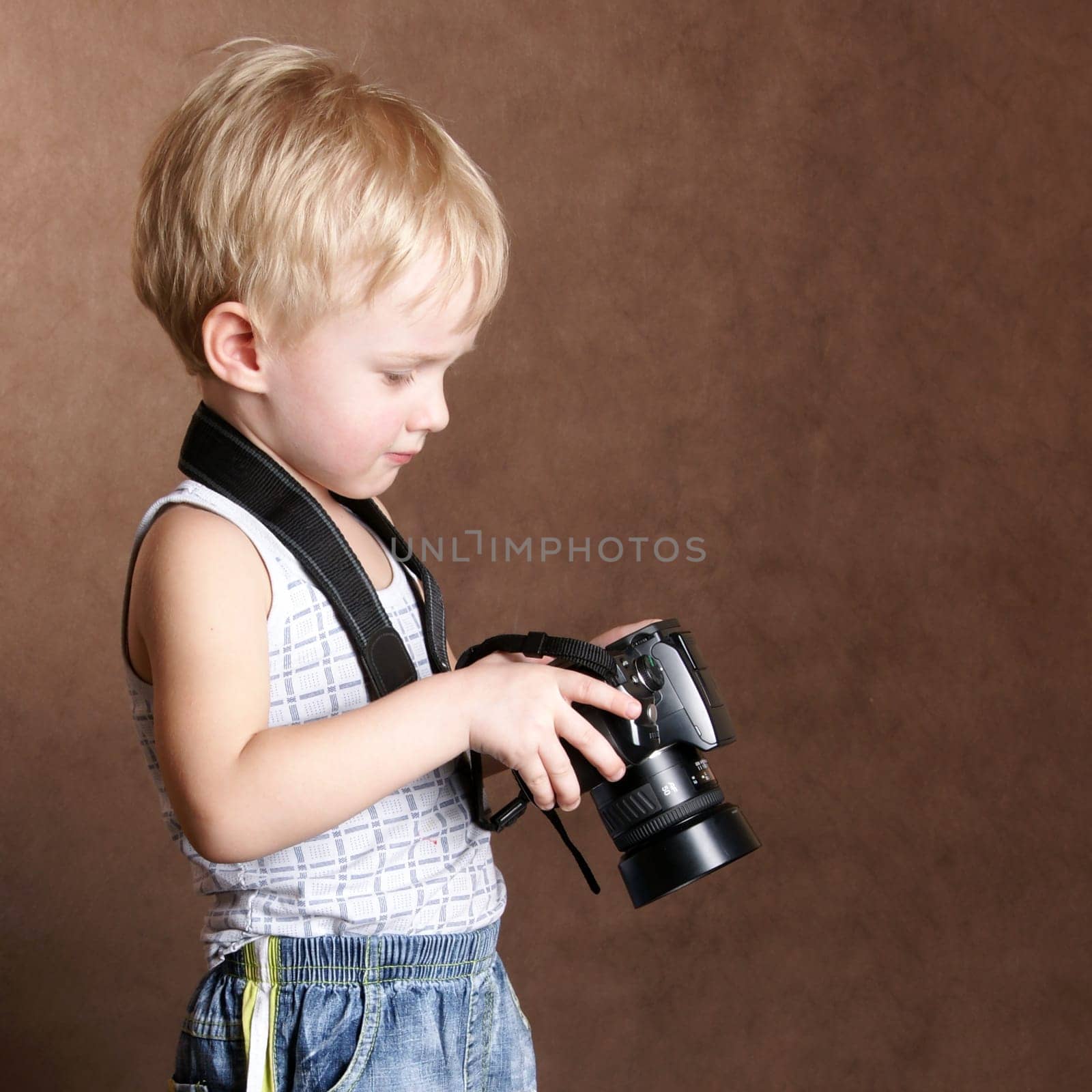 child in studio with professional camera