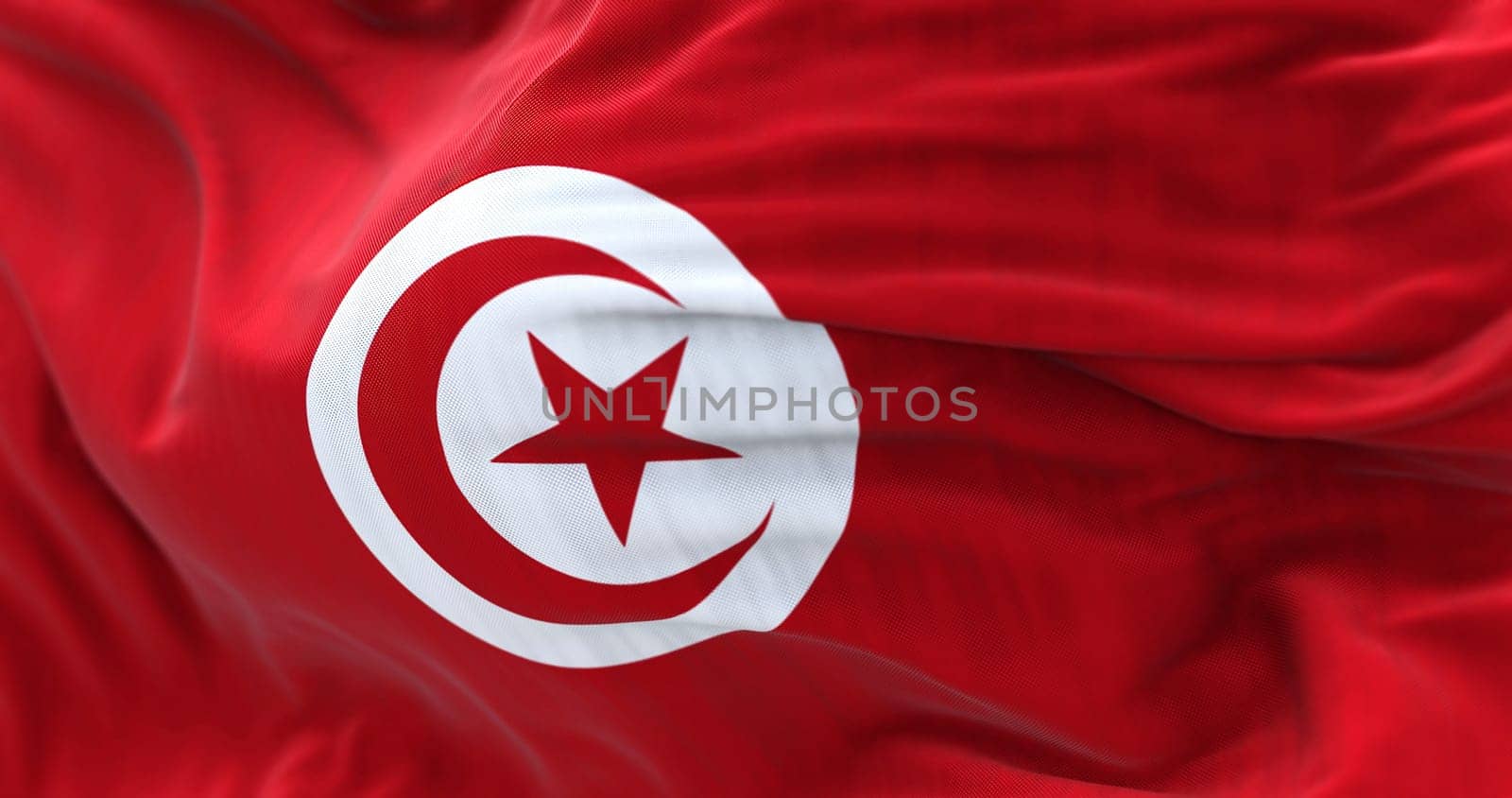 Close-up view of the Tunisia national flag waving in the wind. The Republic of Tunisia is the northernmost country in Africa. Fabric textured background. Selective focus. 3d illustration