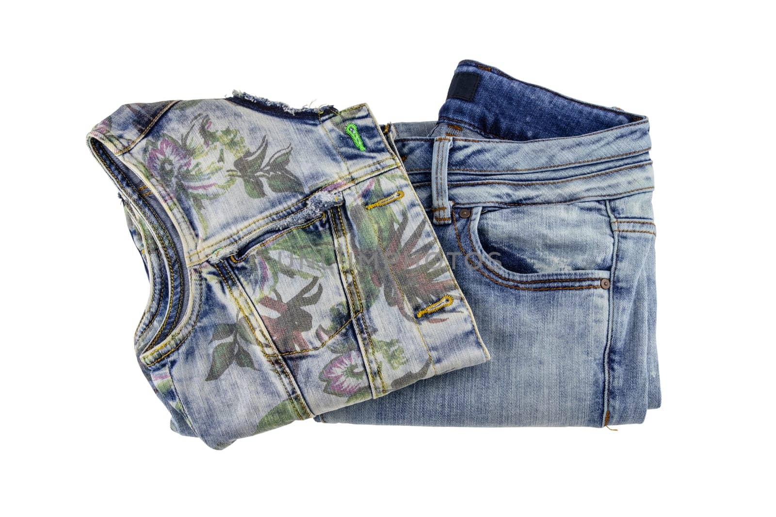 Women jeans fashion. A folded sleeveless blue jeans vest or jacket for woman and denim pants isolated on a white background. Clipping path.