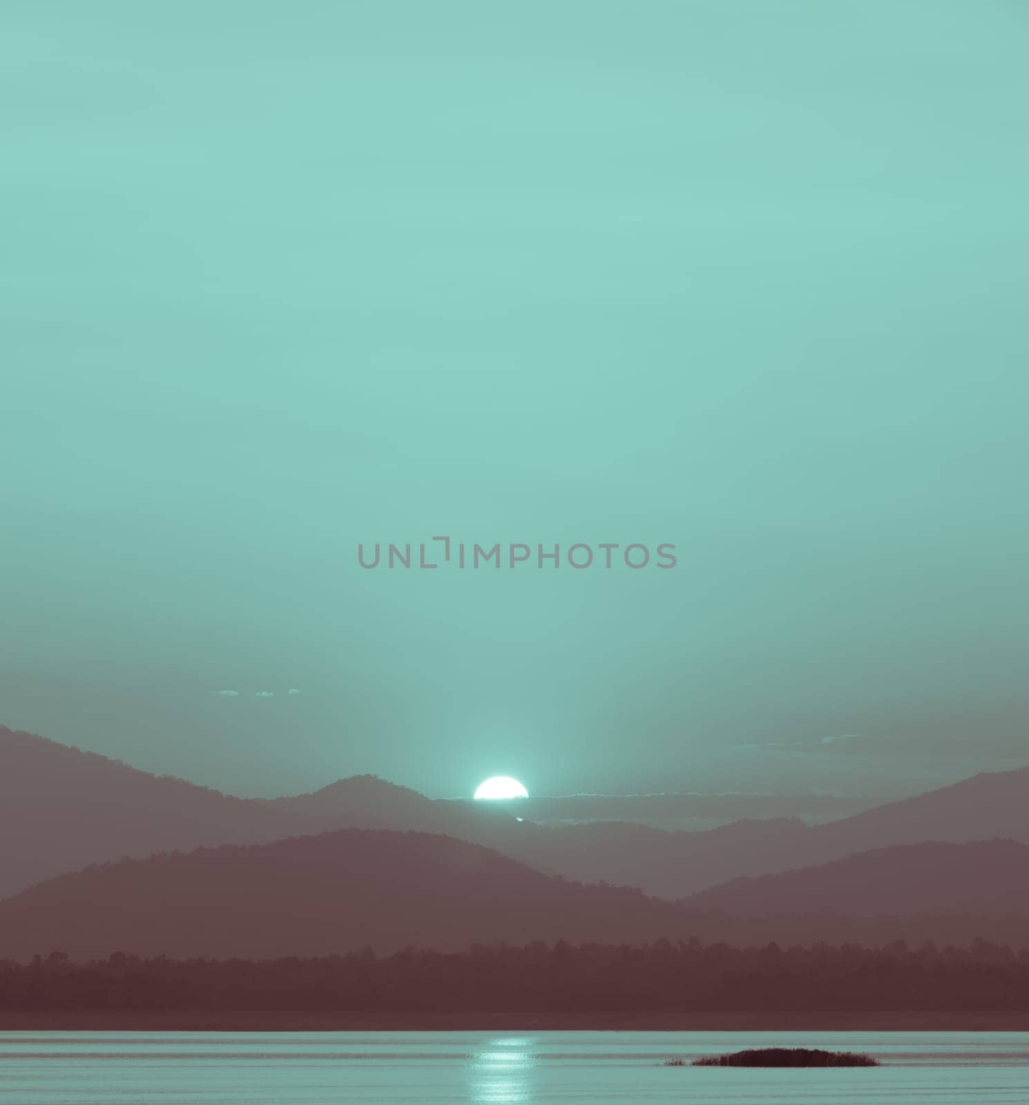 Beautiful sunset over the mountain with reflection on lake