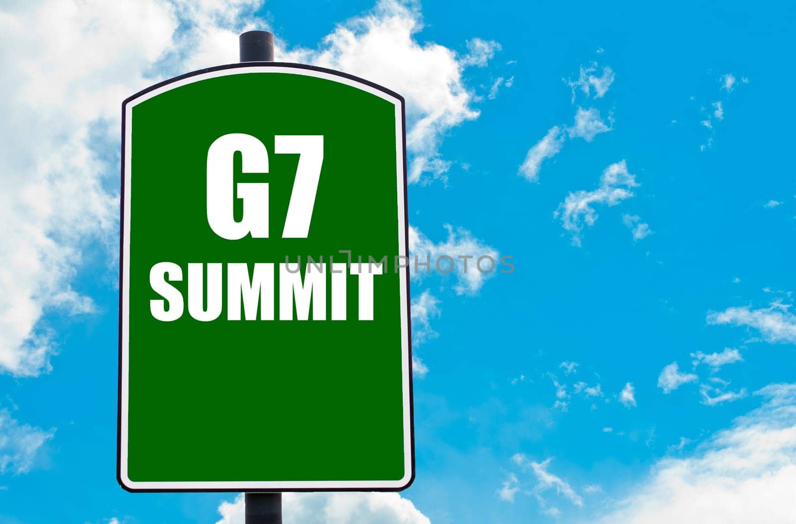G7 SUMMIT written on green road sign  against clear blue sky background. Concept image with available copy space