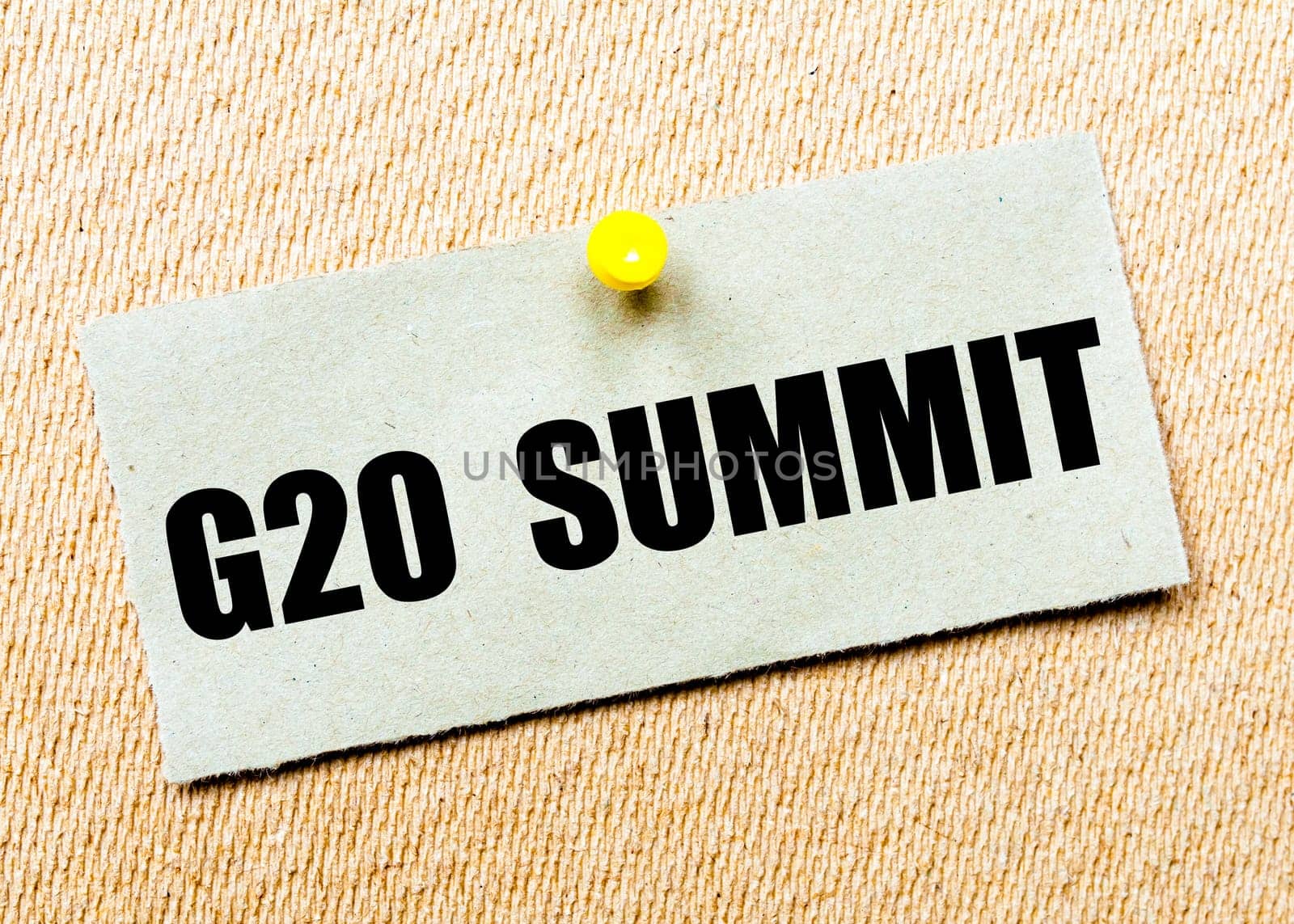 Recycled paper note pinned on cork board with words G20 SUMMIT. Concept Image