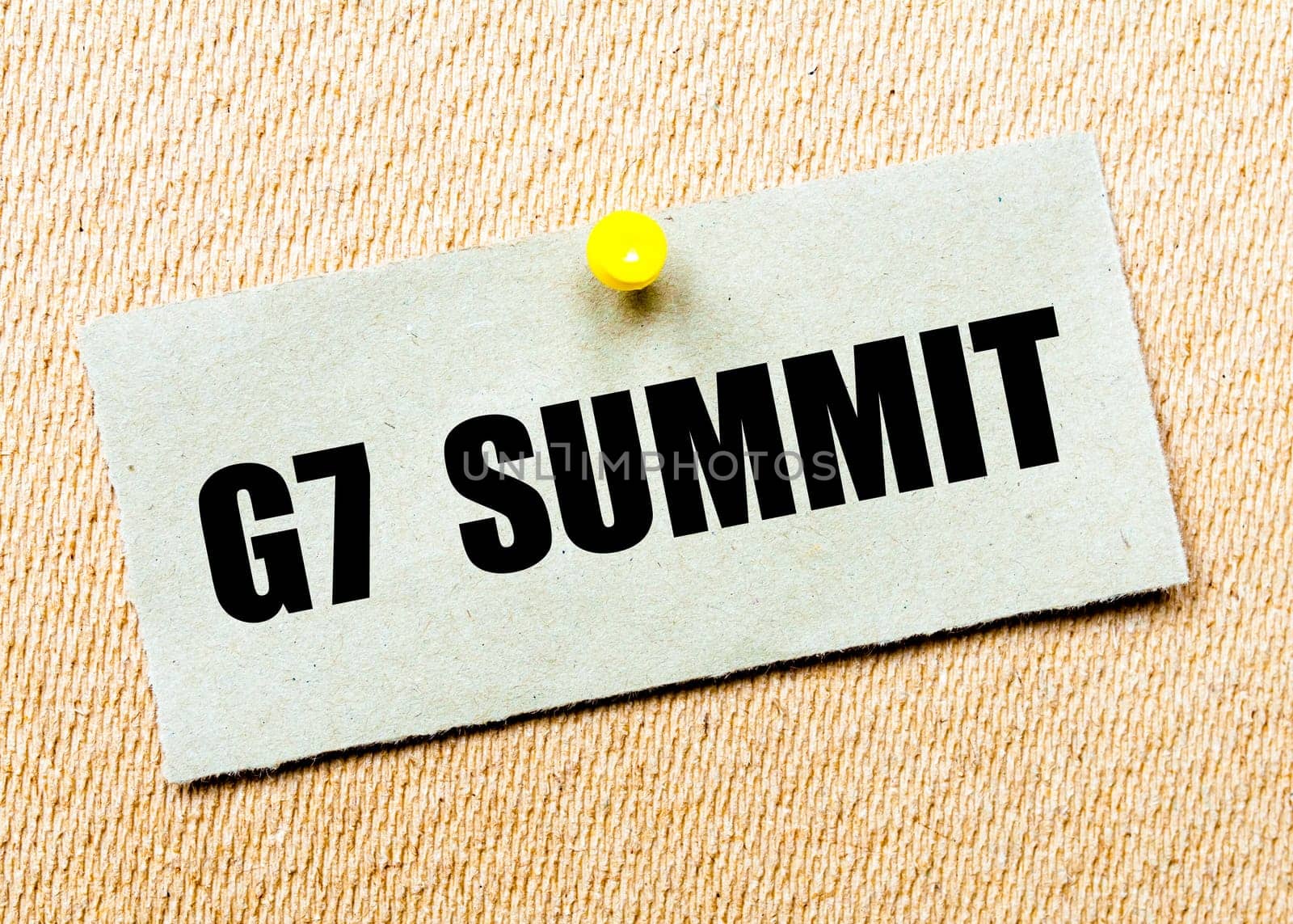 Recycled paper note pinned on cork board with words G7 SUMMIT. Concept Image