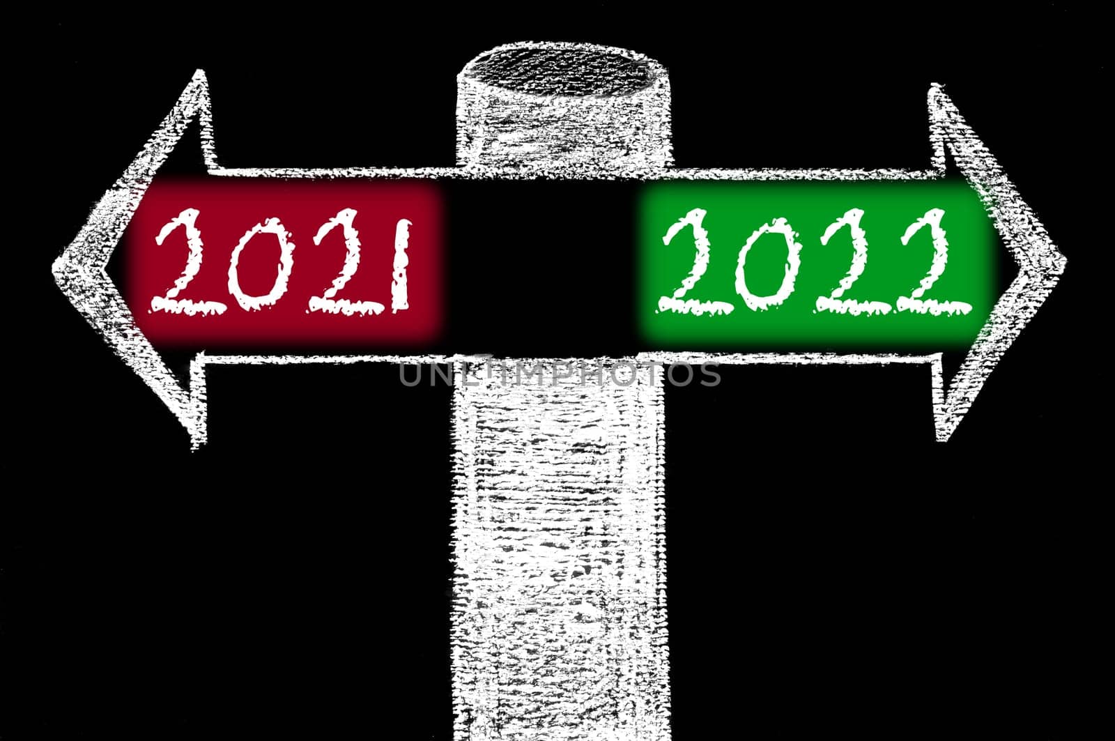 Opposite arrows with Year 2021 versus Year 2022. Hand drawing with chalk on blackboard. Choice conceptual image