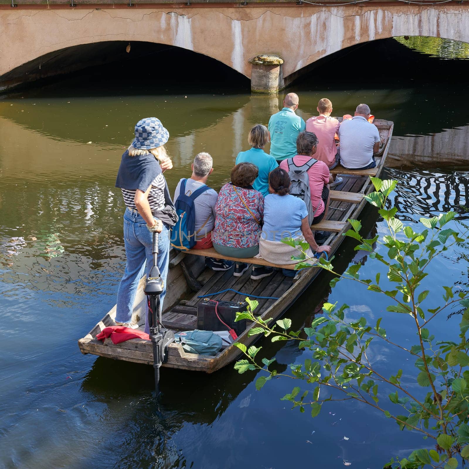 Tourists during a boat trip on the river Lauch in the old town of Colmar in France