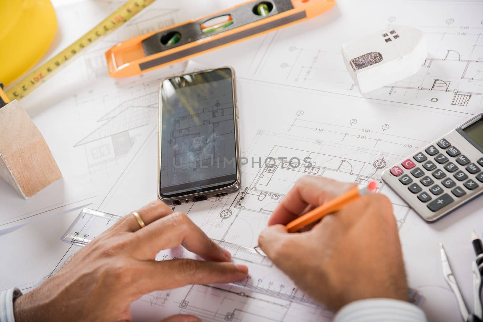 Architect workplace. Architectural building design and construction plans with blueprints paper project plans, designing man edit building or architecture online check by smart mobile phone screen