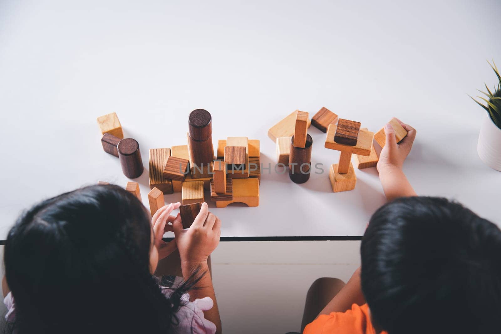 Children boy and girl playing with constructor wooden block building, Happy little kids play wood block stacking board game at home, activities learning creative, toys for preschool and kindergarten