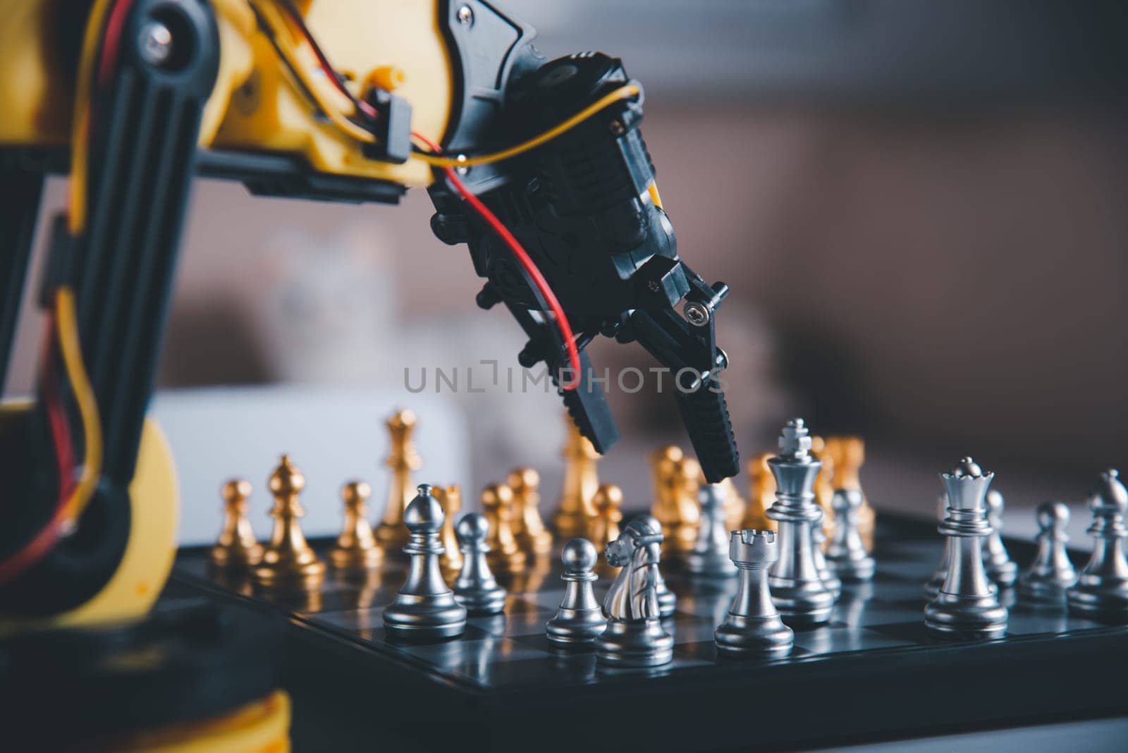 Closeup yellow robot arm playing move chess on chessboard, STEM education E-learning, Technology science robot education concept