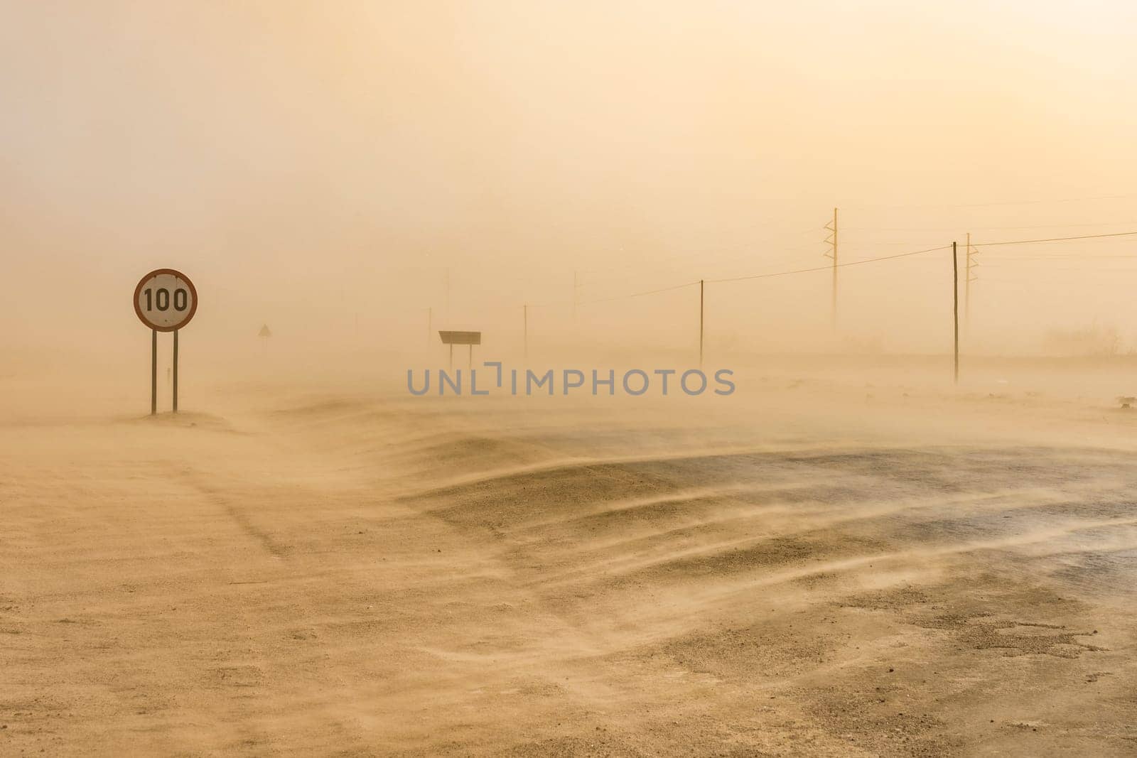 Sandstorm covering the road from Swakopmund to Walvis Bay in Namibia in Africa.