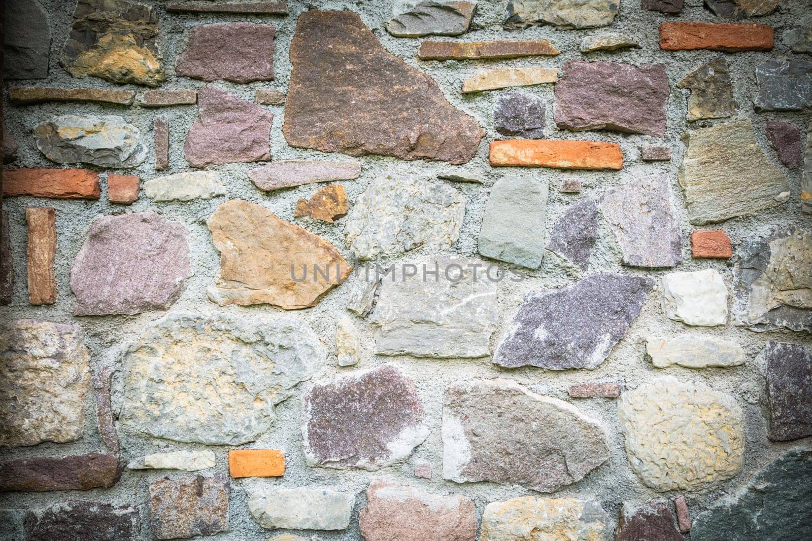 Old brick wall, old texture of withe and red stone blocks closeup