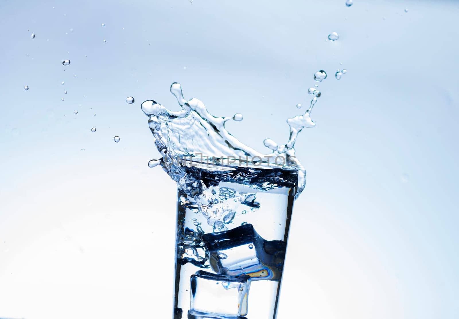 The image of pouring drinking water, into a glass, that makes one feel refreshed on blurred white background, Splashing water, Sparkling water