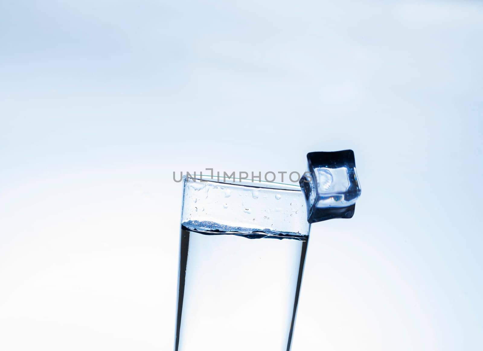 The image of pouring drinking water, into a glass, that makes one feel refreshed on blurred white background, Splashing water, Sparkling water