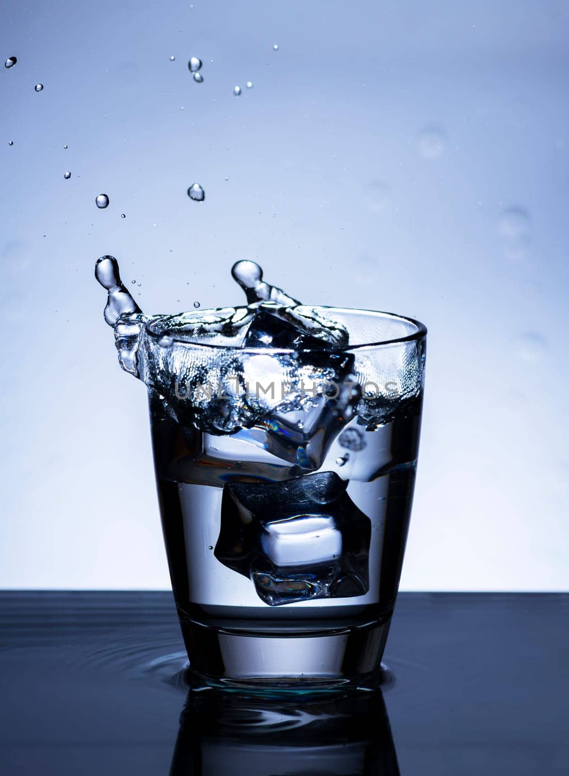 The image of pouring drinking water, into a glass, that makes one feel refreshed on blurred white background, Splashing water, Sparkling water