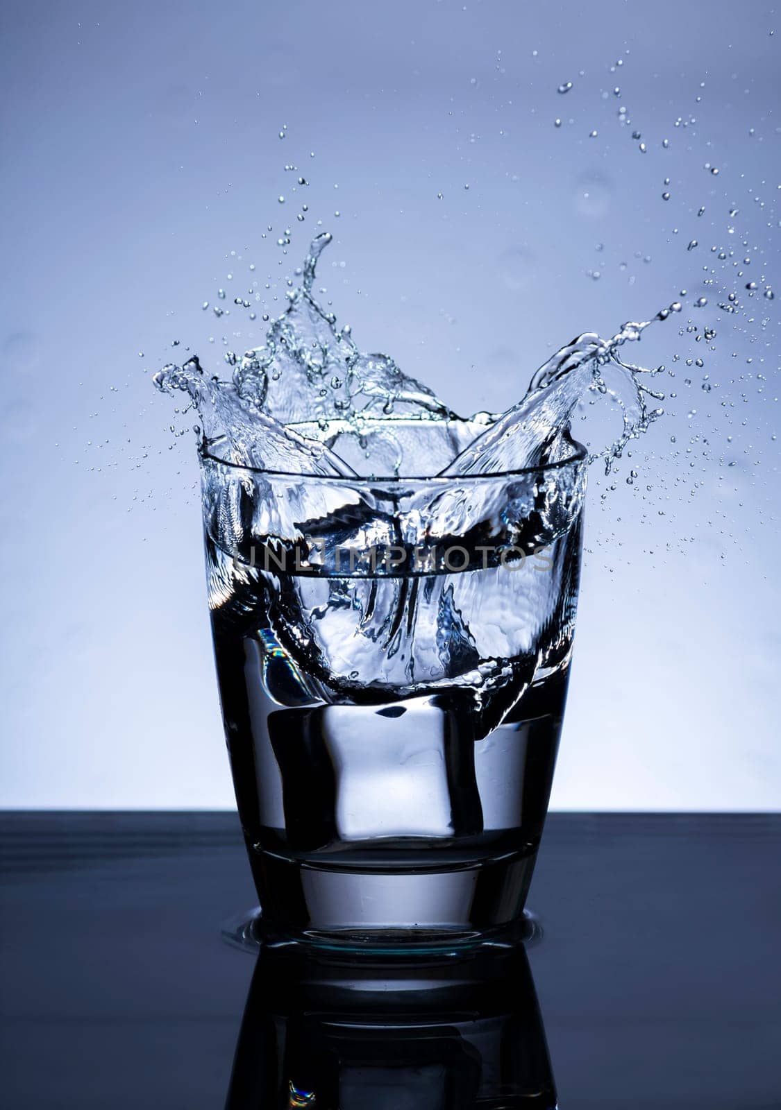 The image of pouring drinking water, into a glass, that makes one feel refreshed on blurred white background, Splashing water, Sparkling water