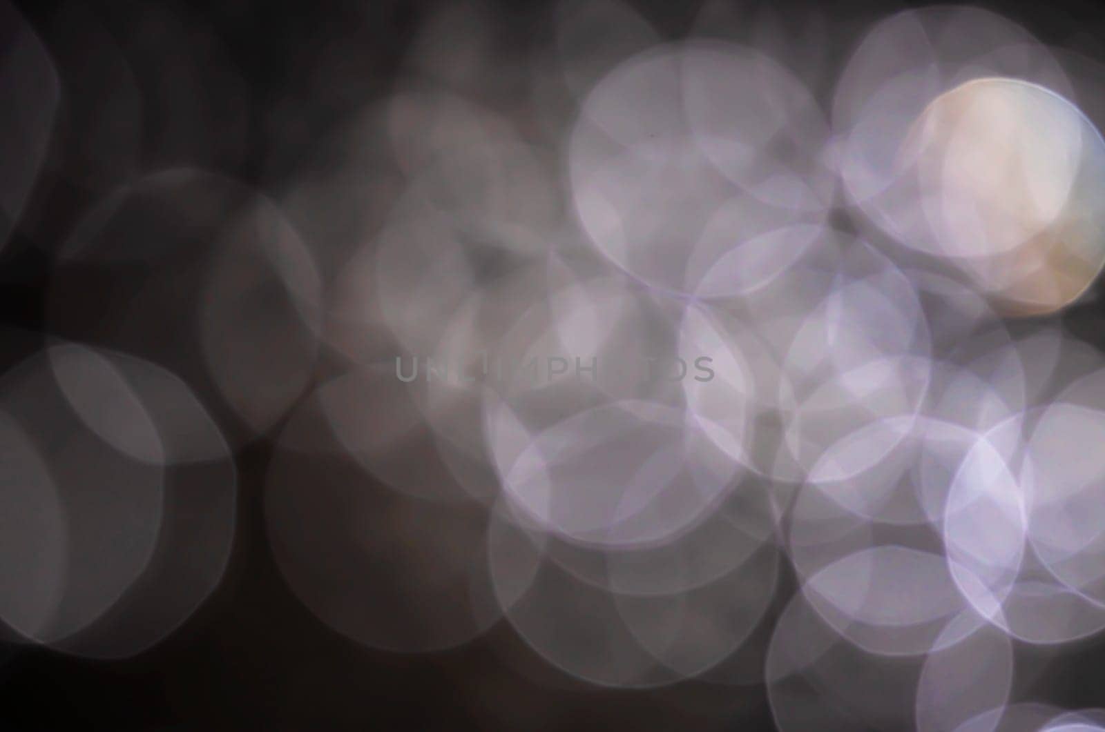 Light abstract dark bokeh christmas circle color glitter blurred black background