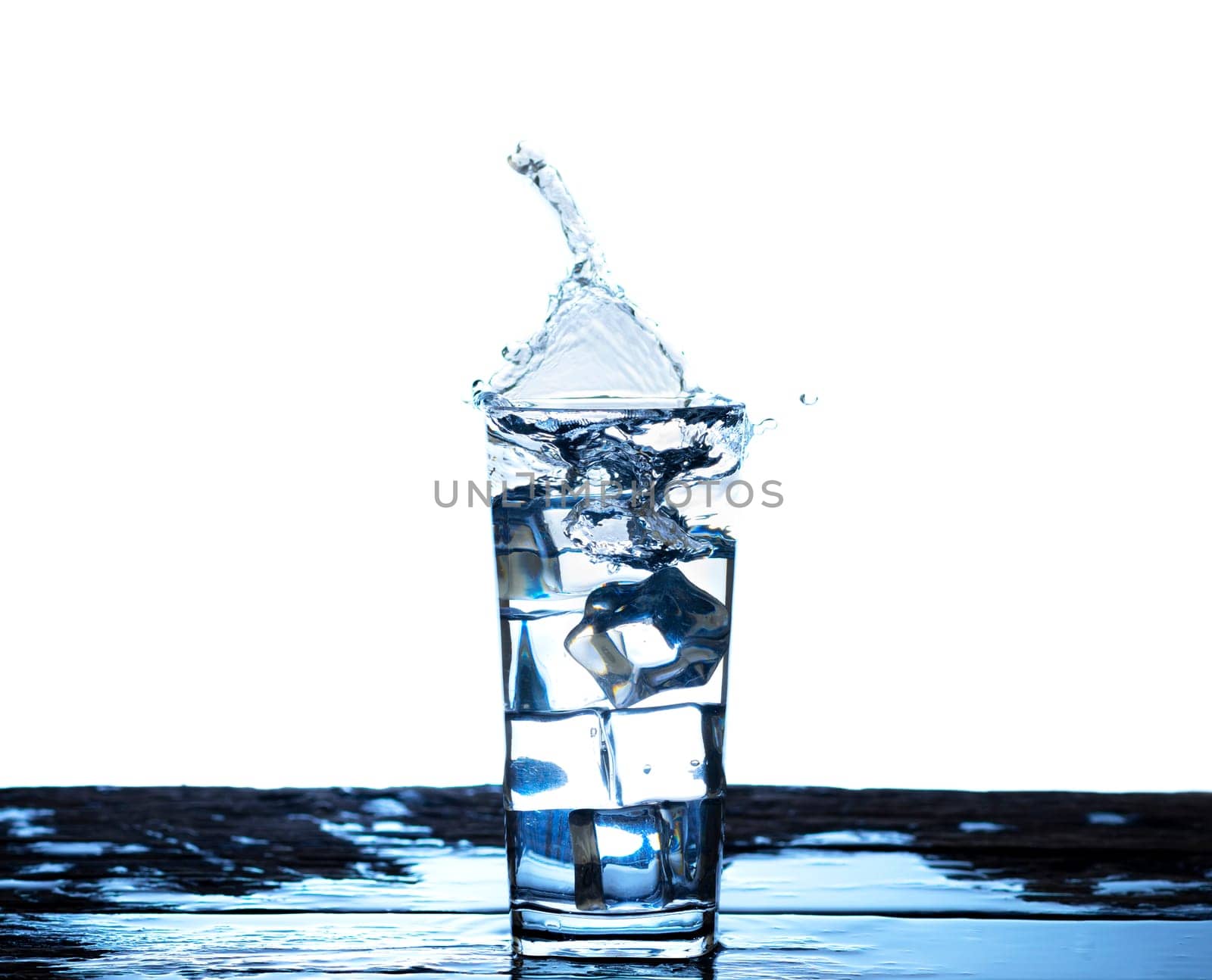 The image of pouring drinking water, into a glass, that makes one feel refreshed on blurred white background, Splashing water, Sparkling water