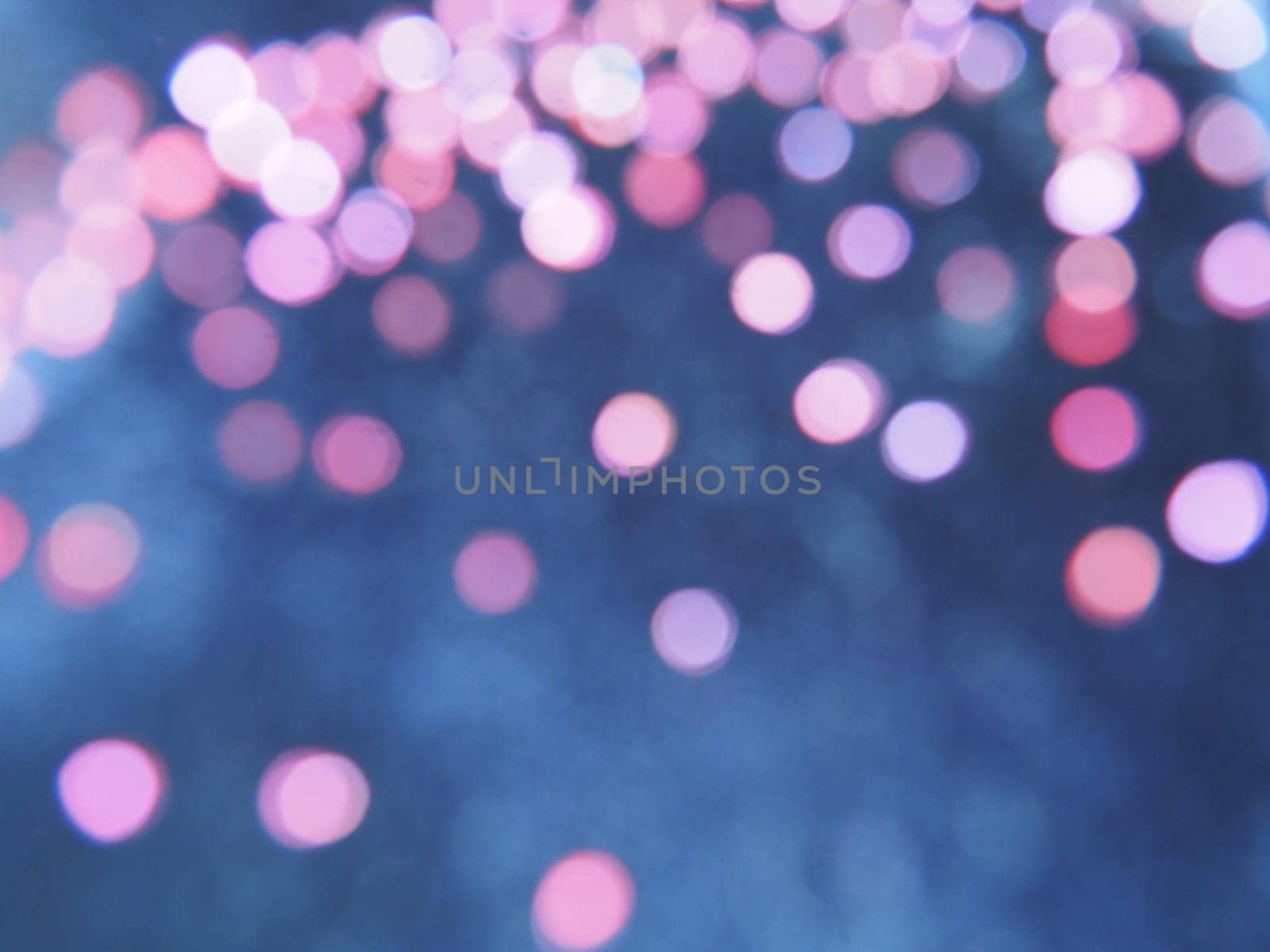 Beautiful side on a dark background. Pink shimmer and circles on a blue and gray background. Festive abstract background.