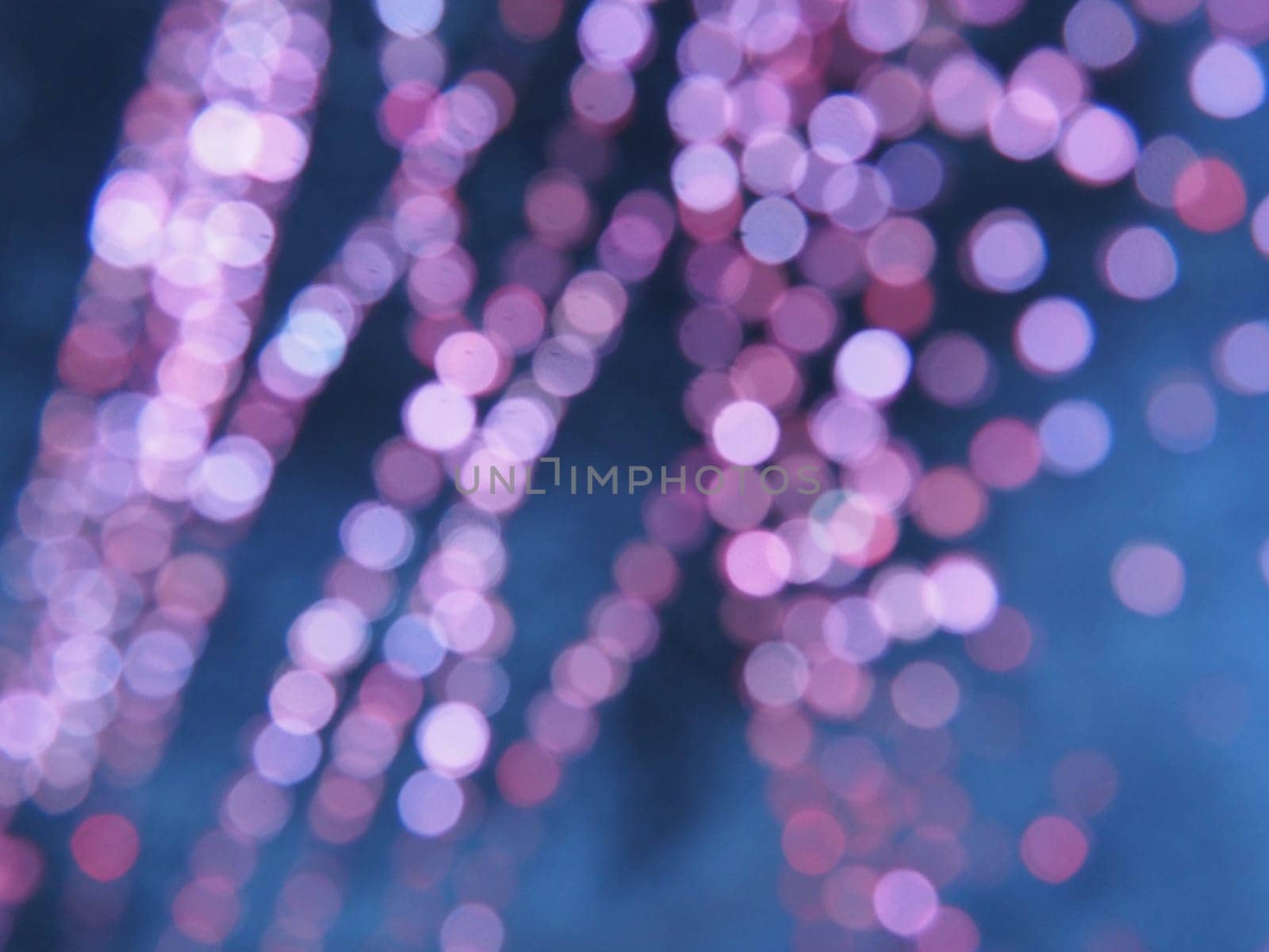 Beautiful side on a dark background. Pink shimmer and circles on a blue and gray background. Festive abstract background.