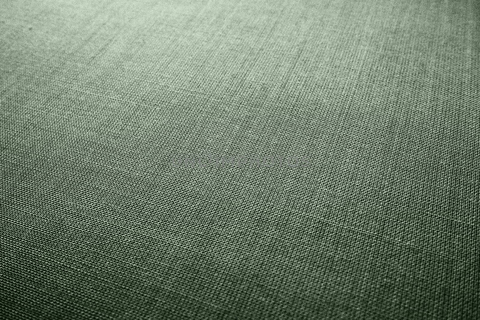 green background fabric texture. A piece of woolen cloth is neatly laid out on the surface. Weave and textile texture. Dress fabric or for kitchen needs, tablecloth or curtains, close-up. Dash.