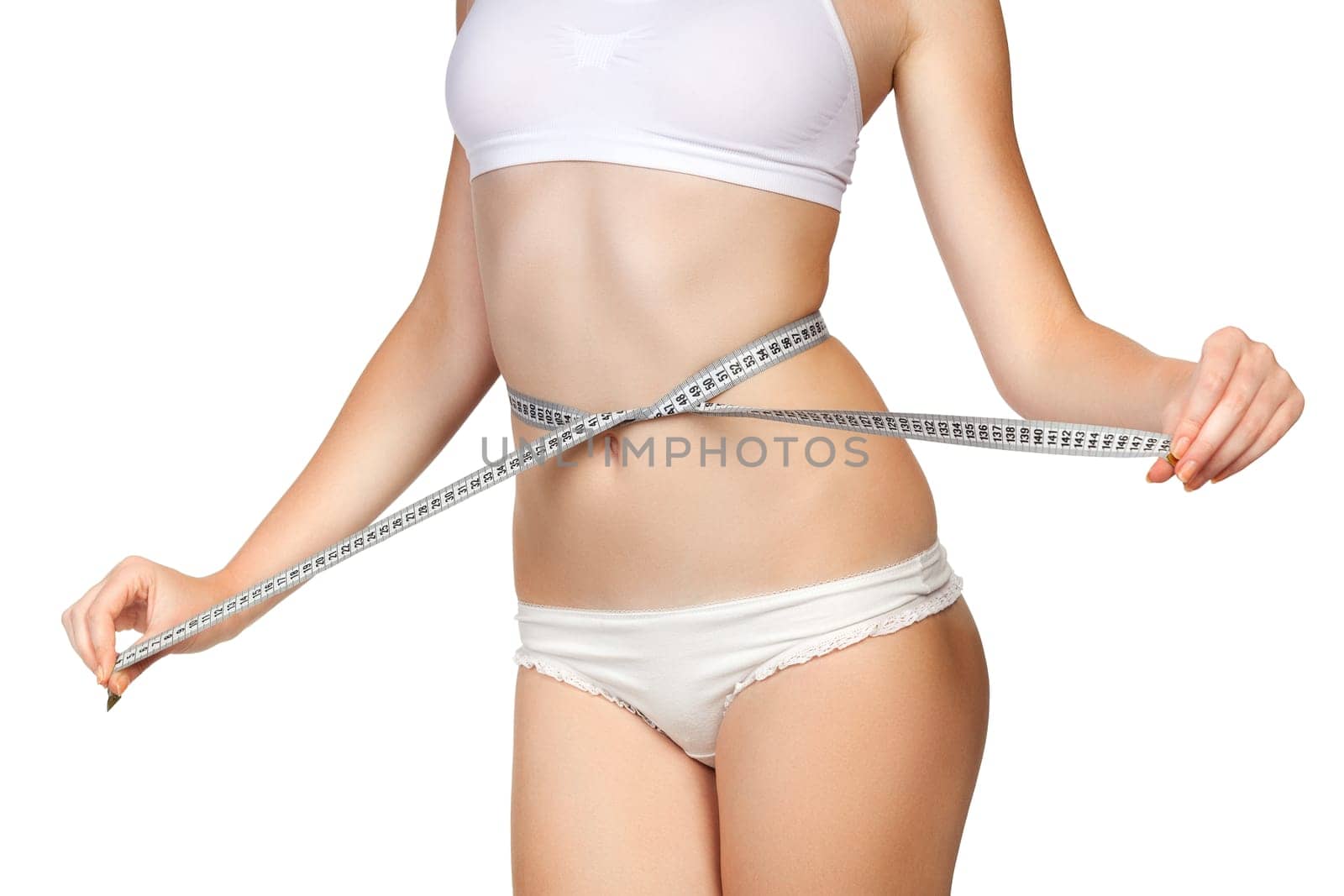 Woman measuring her waist with a tape meter, isolated on white background