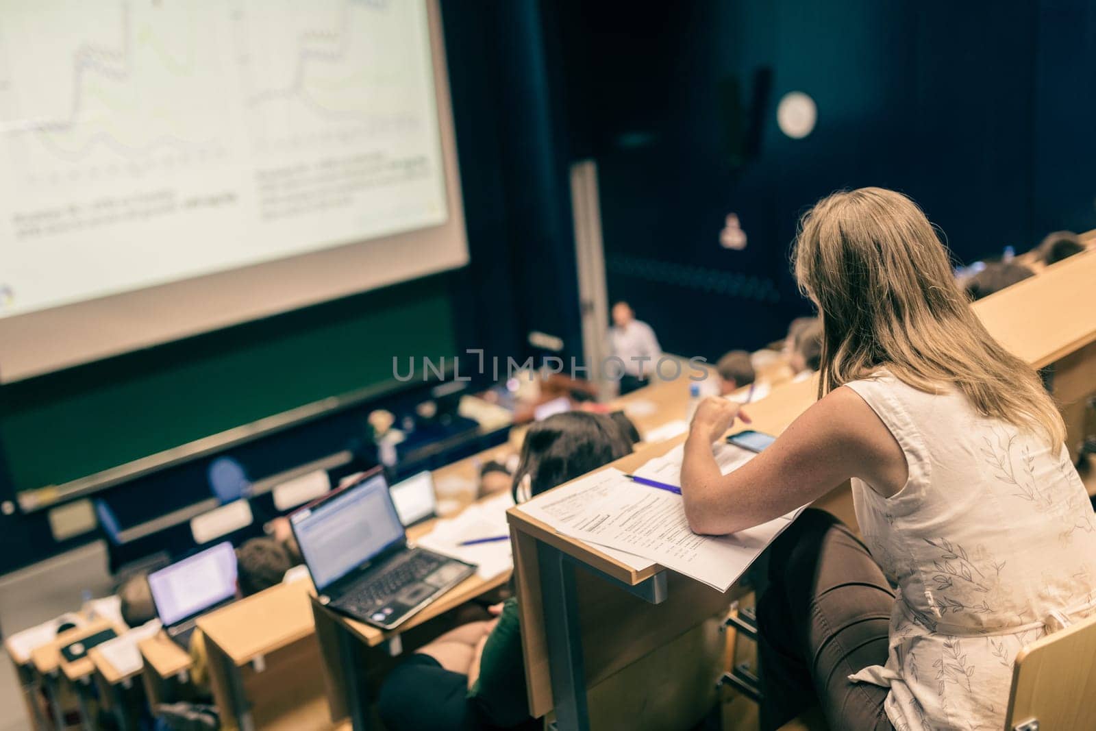 Conference and Presentation. Audience at the conference hall. Business and Entrepreneurship. Faculty lecture and workshop. Audience in the lecture hall. Academic education. Student making notes.