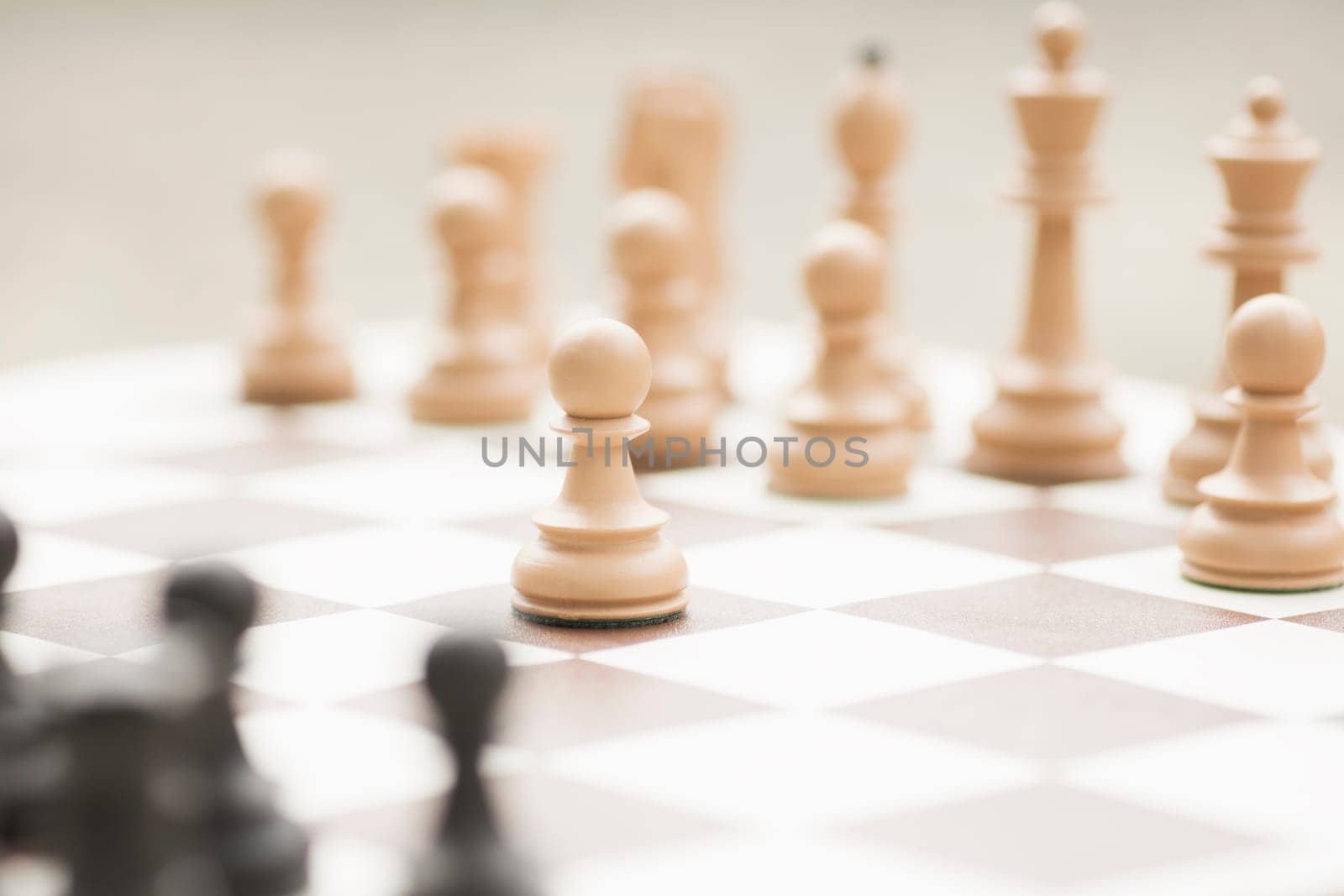 The white pawn chess piece is starting the game on chessboard.