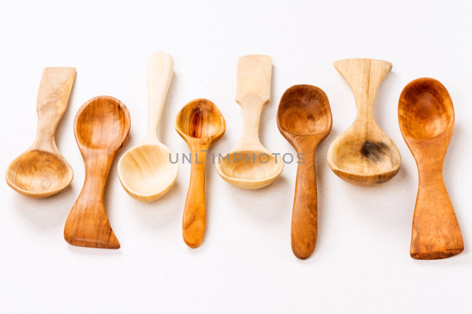Wooden spoons are on white background, wood carving concept.