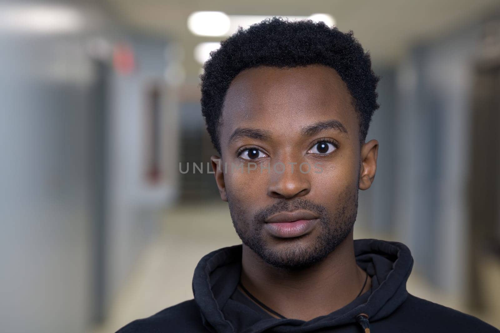 man at university corridor education student at school campus smart looking classmate