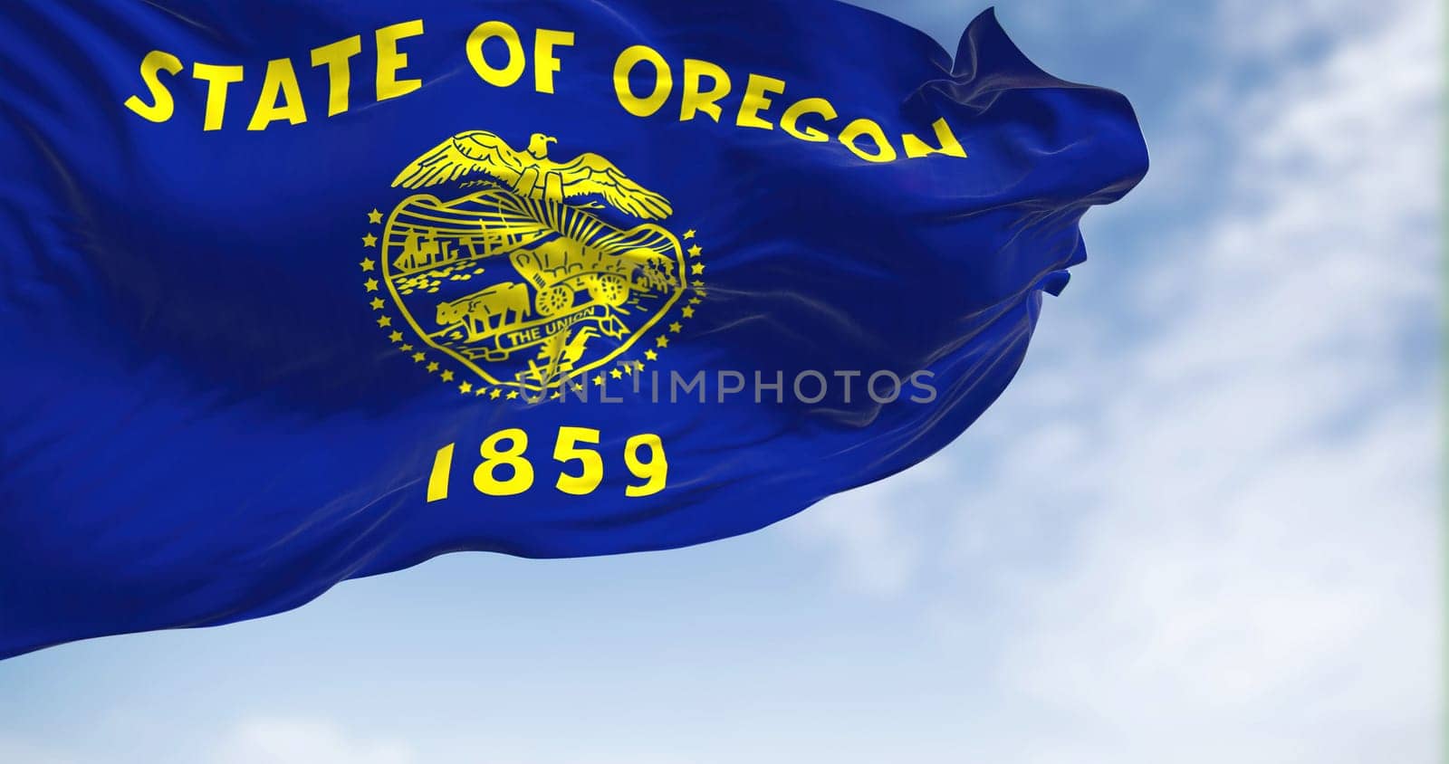 Oregon state flag waving on a clear day. Oregon is a state in the Pacific Northwest region of the Western United States. Fabric textured background. Selective focus. 3D illustration