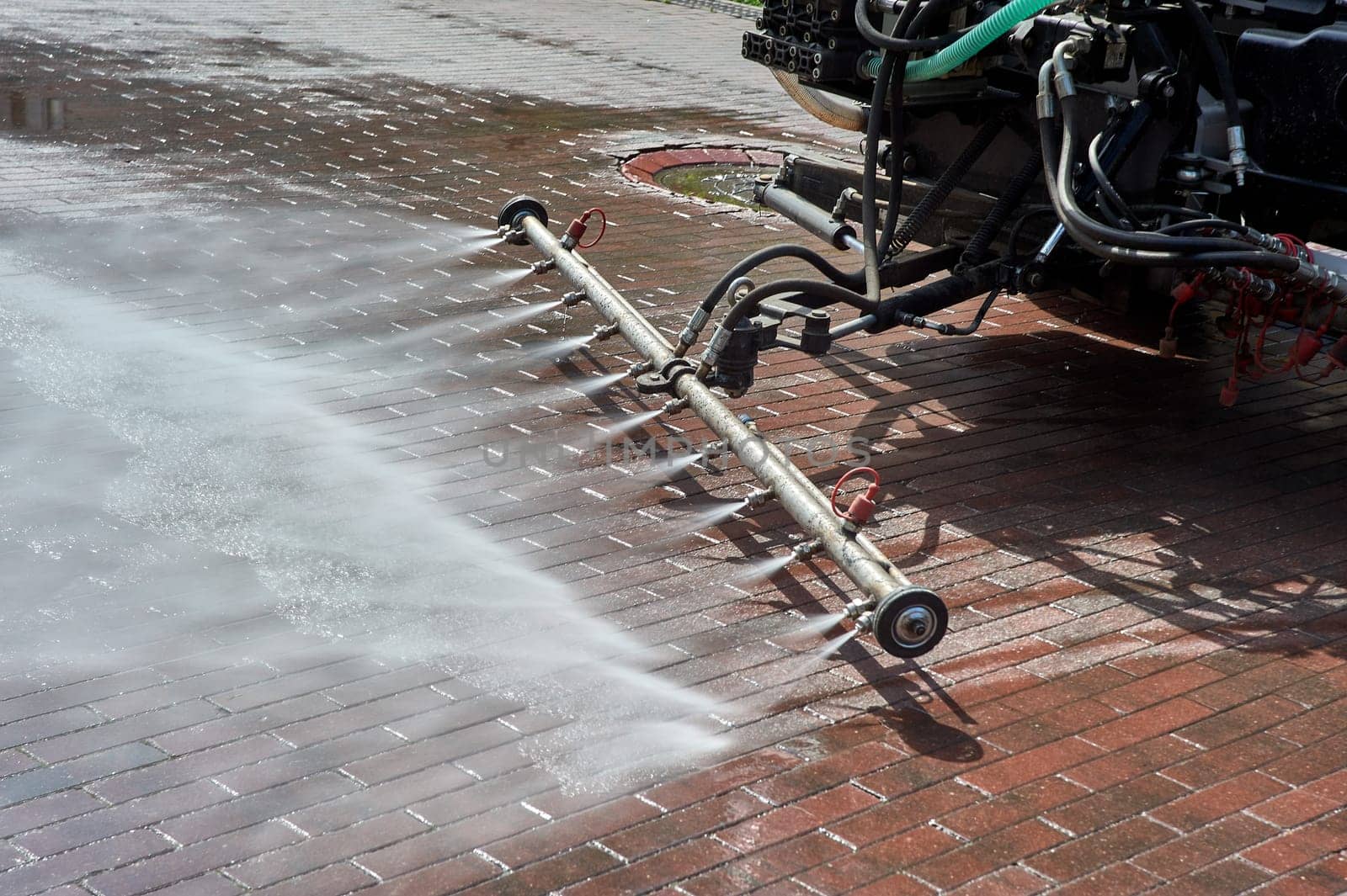 A special machine washes city paths and roads with water. High quality photo