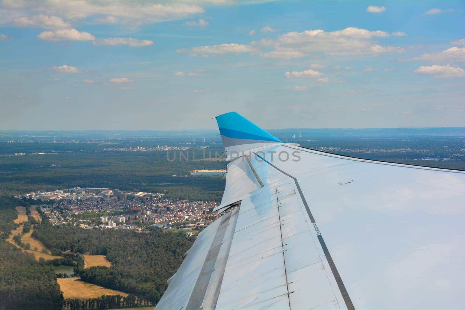 Departure from Frankfurt am Main Airport in Germany, looking towards the aircraft wing and the Frankfurt area shortly after takeoff
