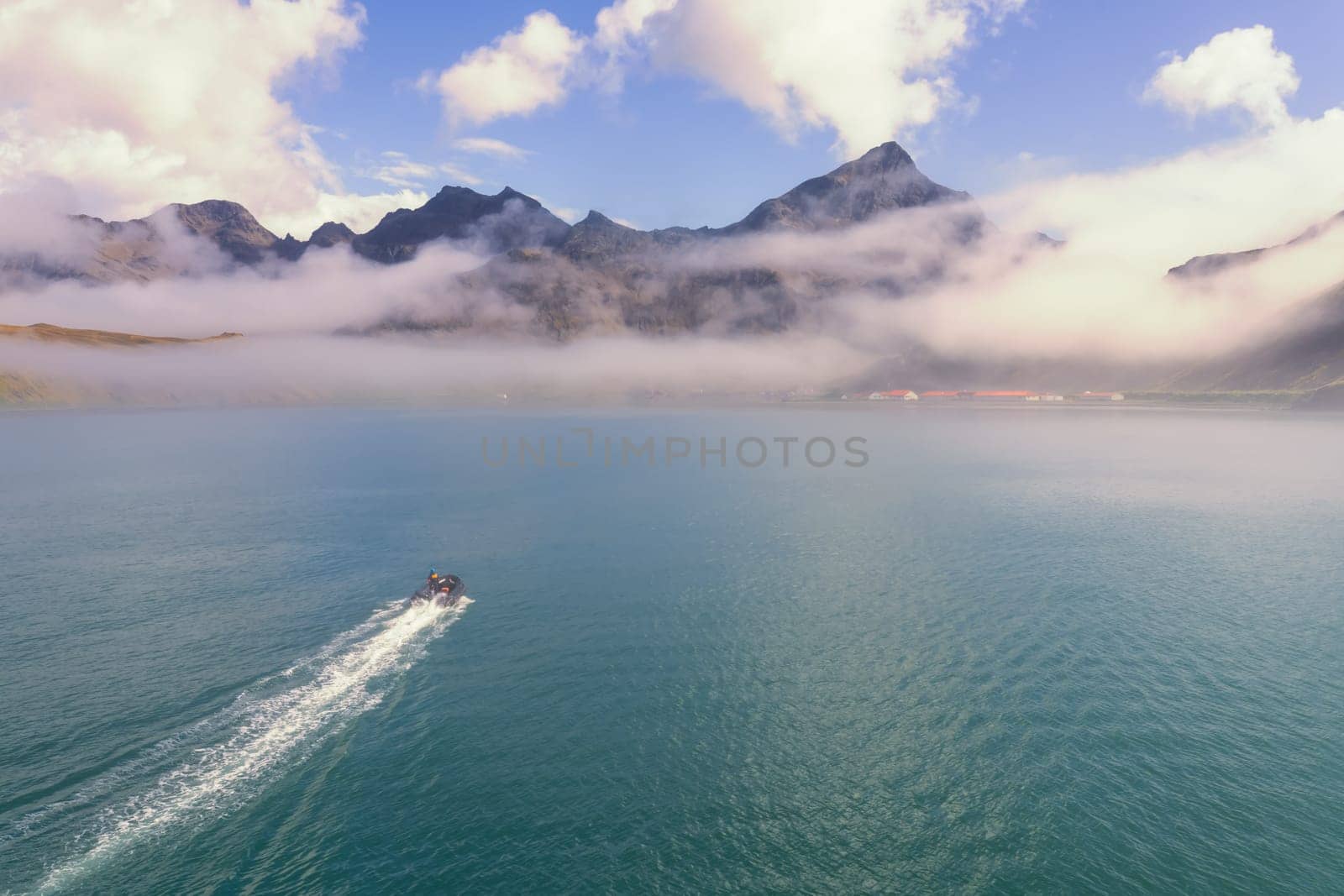 A tourist Zodiac enters the foggy bay of the now abandoned whaling station at Grytviken - on the island of South Georgia.