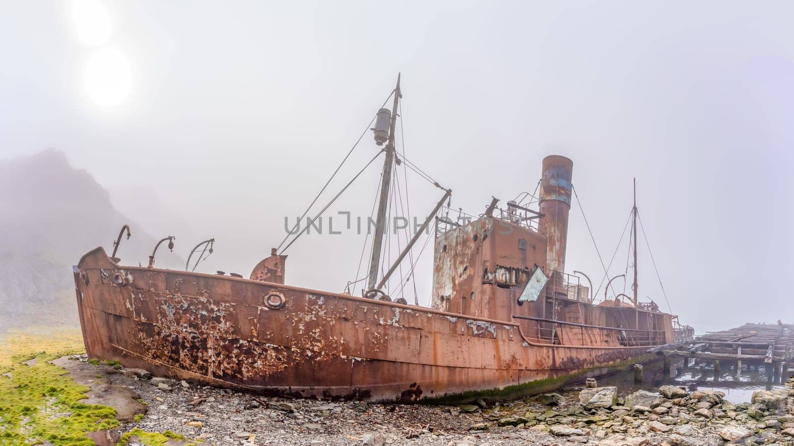 Old, rusty whaling ships and processing facilities at a now abandoned whaling station in Grytviken -on the island of South Georgia.