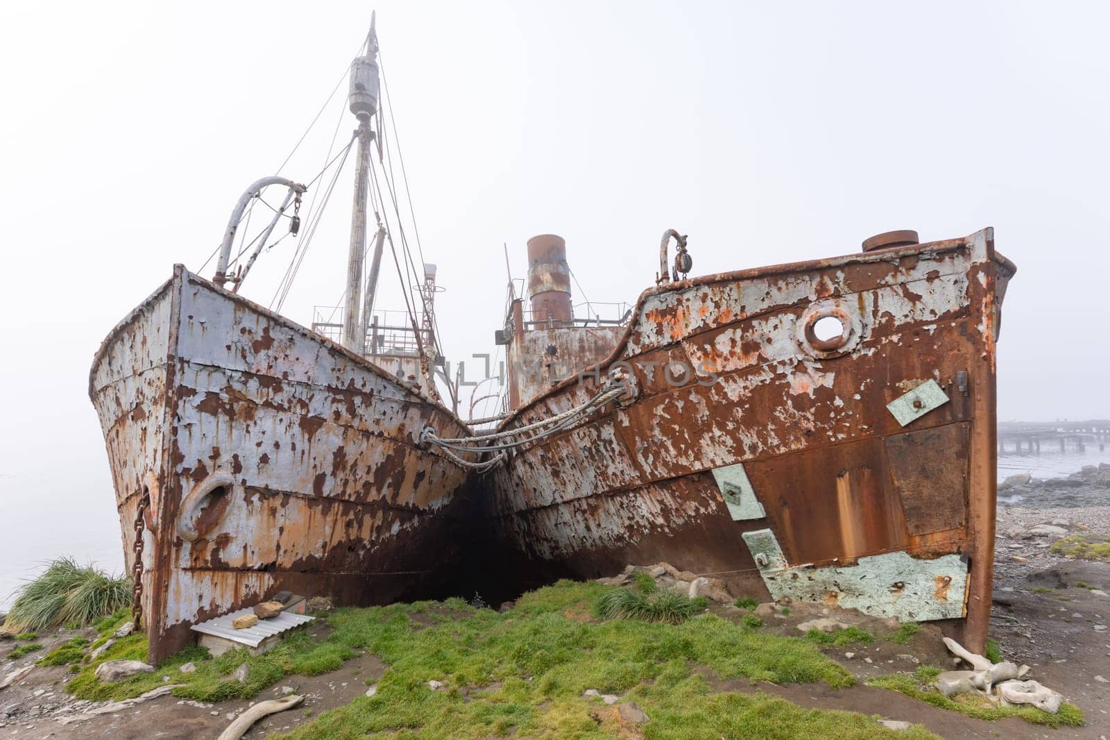 Old, rusty whaling ships and processing facilities at a now abandoned whaling station in Grytviken -on the island of South Georgia.