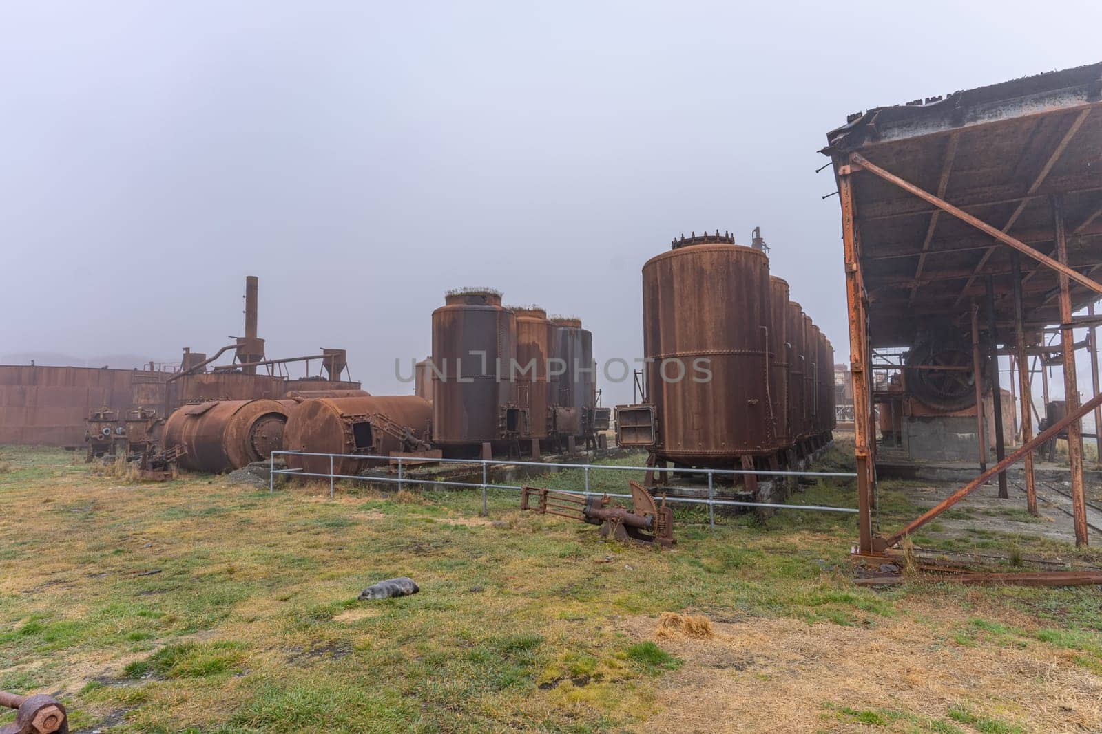 Old, rusty whale oil tanks and processing facilities at a now abandoned whaling station in Grytviken -on the island of South Georgia.