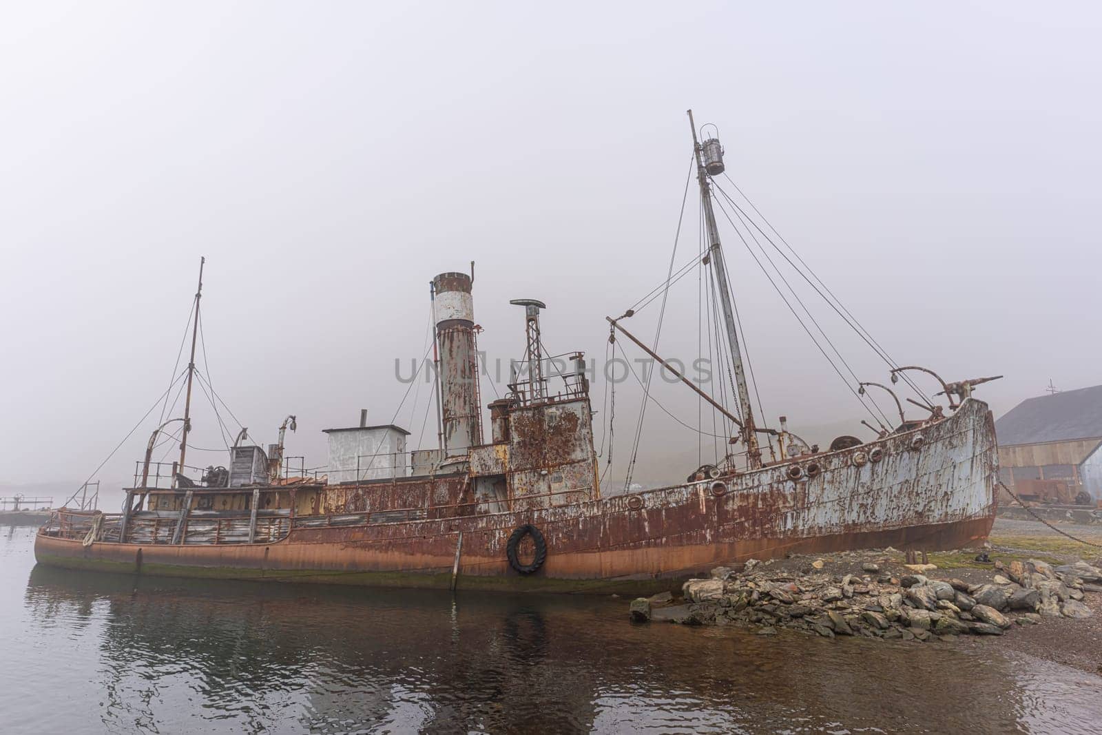 Old, rusty whaling ships and processing facilities at a now abandoned whaling station in Grytviken -on the island of South Georgia.