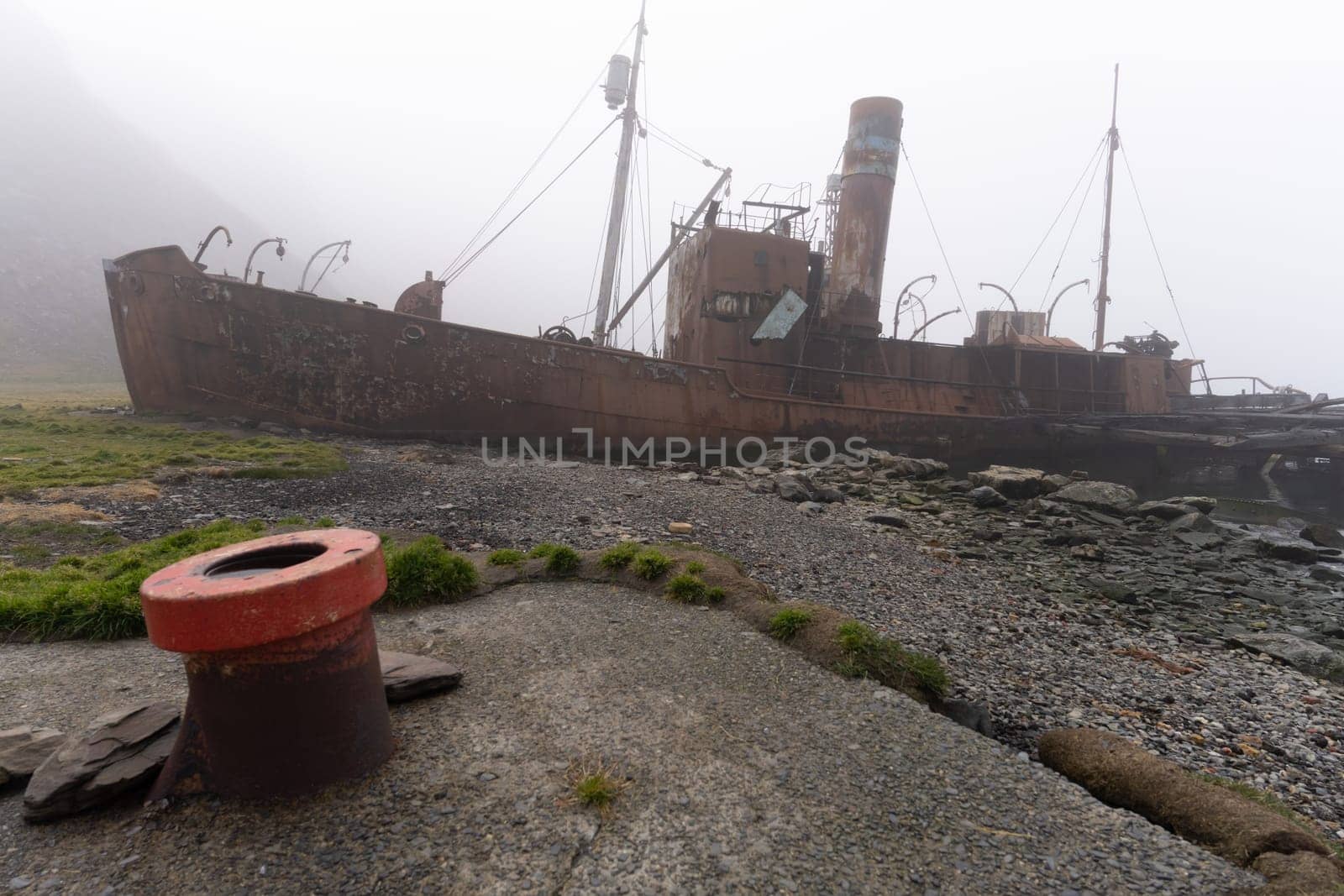 Old, rusty whaling ships and processing facilities at a now abandoned whaling station in Grytviken -on the island of South Georgia.