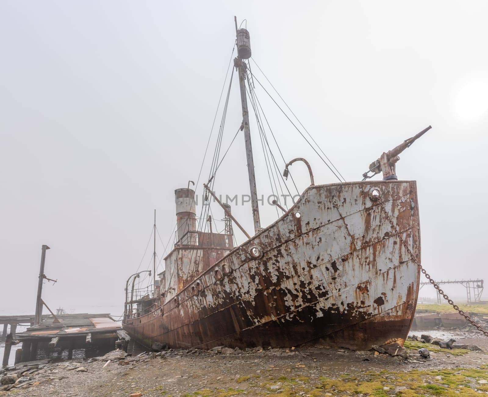 Old, rusty whaling ships and processing facilities at a now abandoned whaling station in Grytviken -on the island of South Georgia.