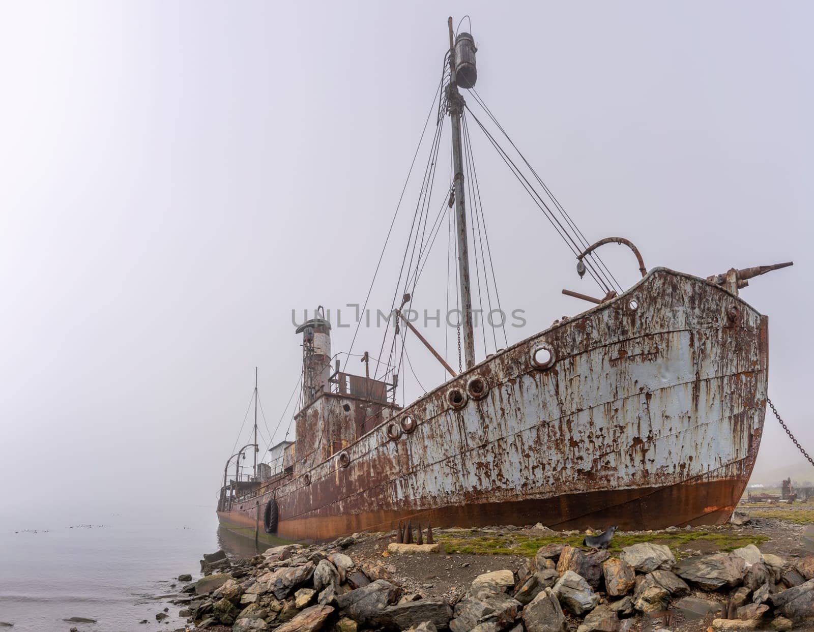 Old, rusty whaling ships and processing facilities at a now abandoned whaling station in Grytviken -on the island of South Georgia.