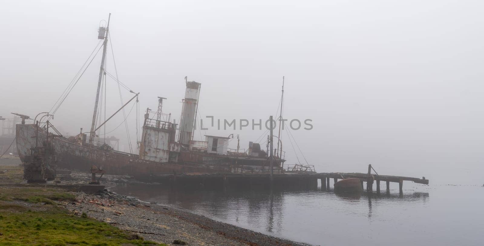 Old, rusty whaling ships and processing facilities at a now abandoned whaling station in Grytviken -on the island of South Georgia.