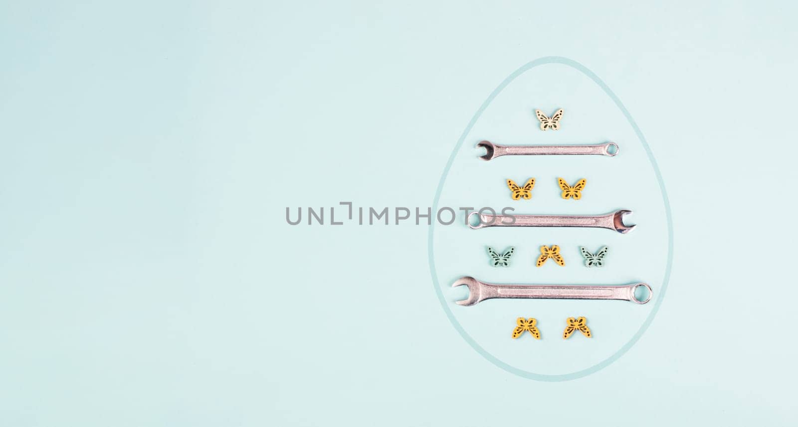 Easter egg with wrenches and butterflies, holiday greeting card with repair tools, spring season
