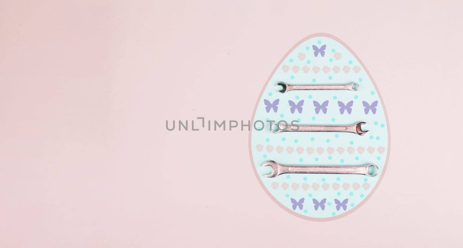 Easter egg with wrenches and butterflies, holiday greeting card with repair tools, spring season