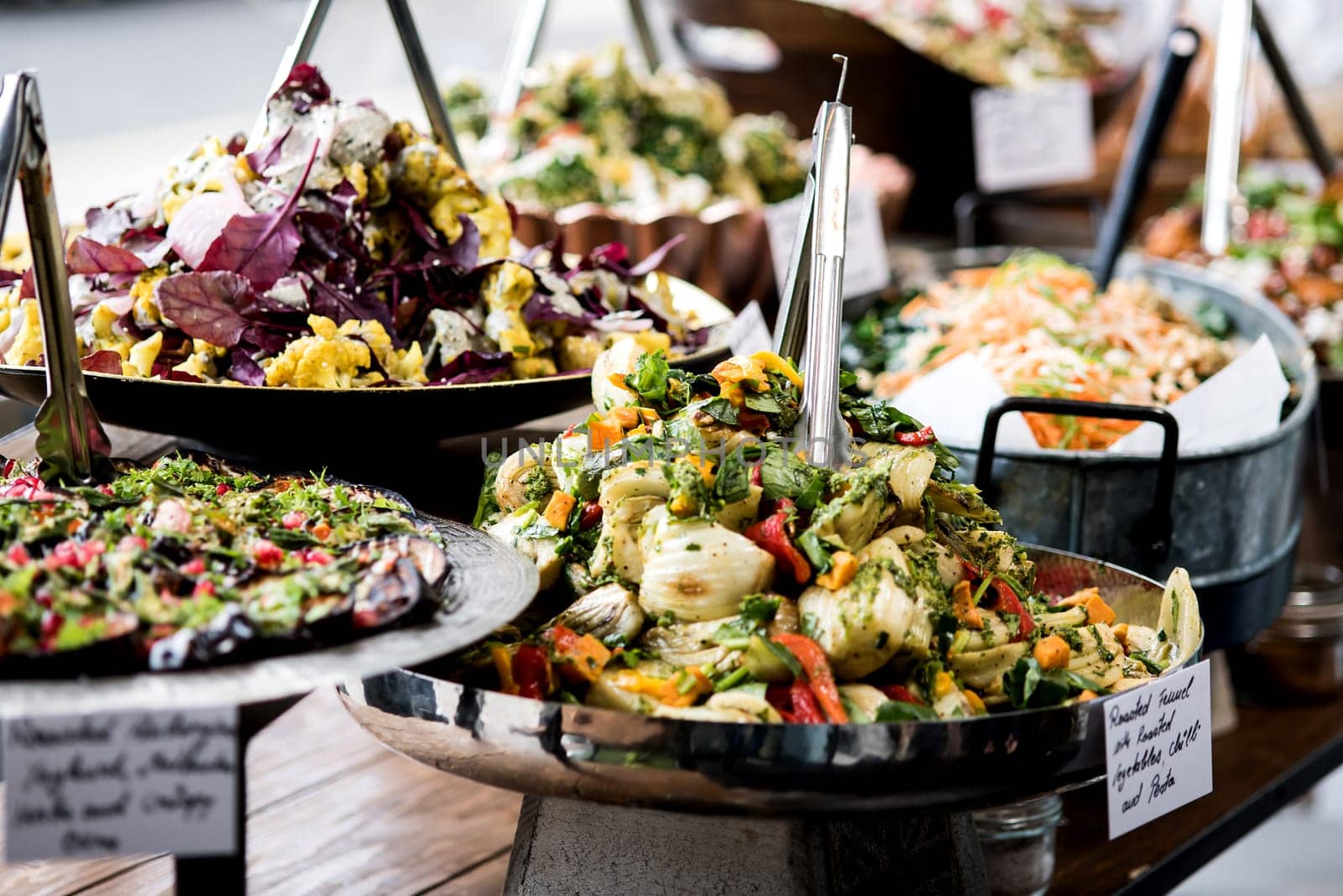 Salads displayed on buffet in individual containers