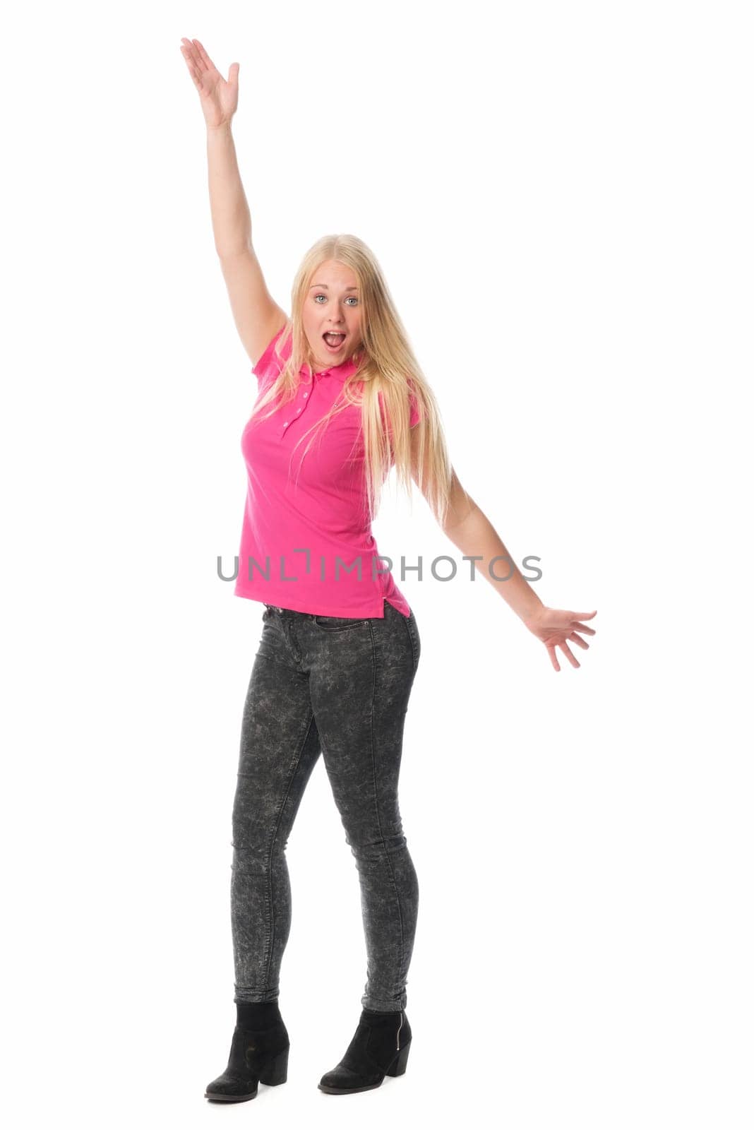 Young woman raises her arms in the air with happiness