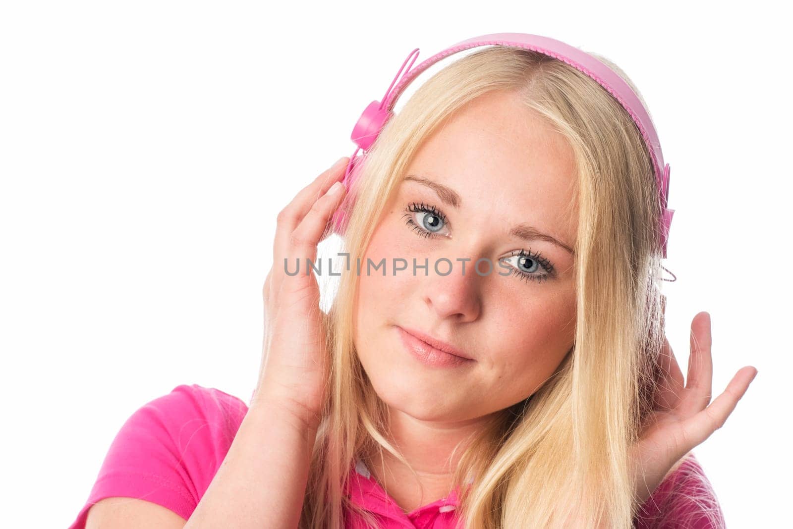 Sensual blonde listens to music via headphones