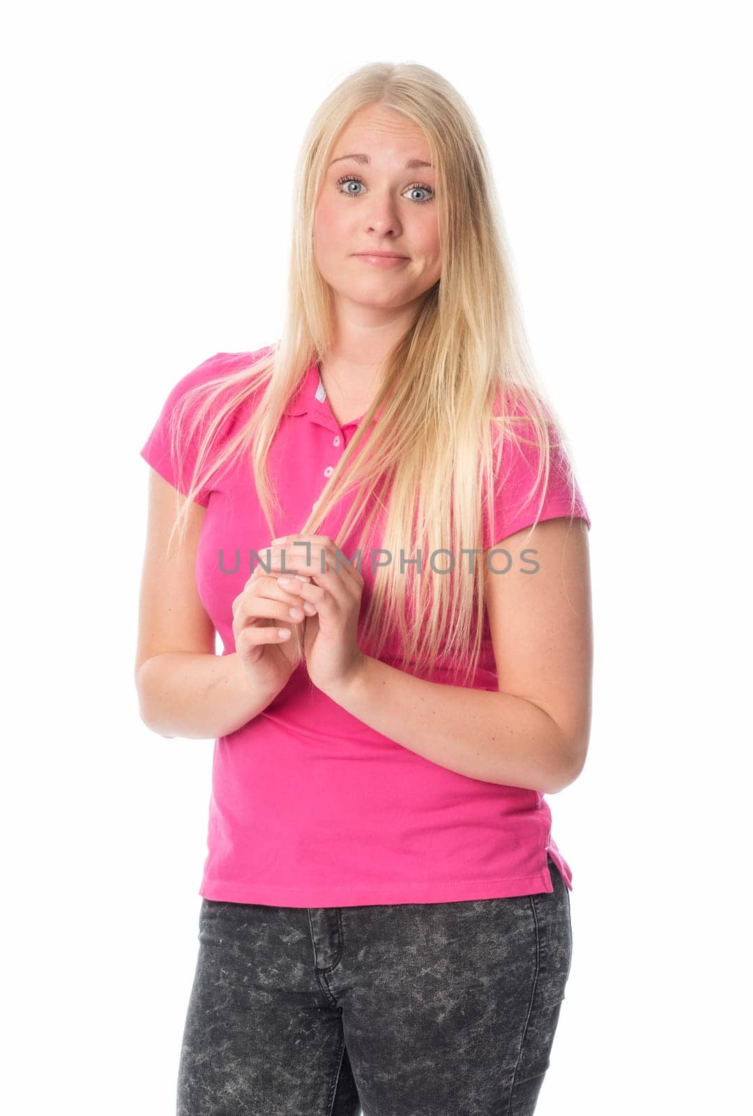 Young blonde girl makes big eyes