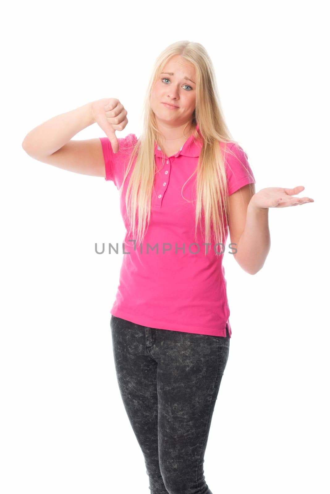 Young woman covers her face and points her thumbs down