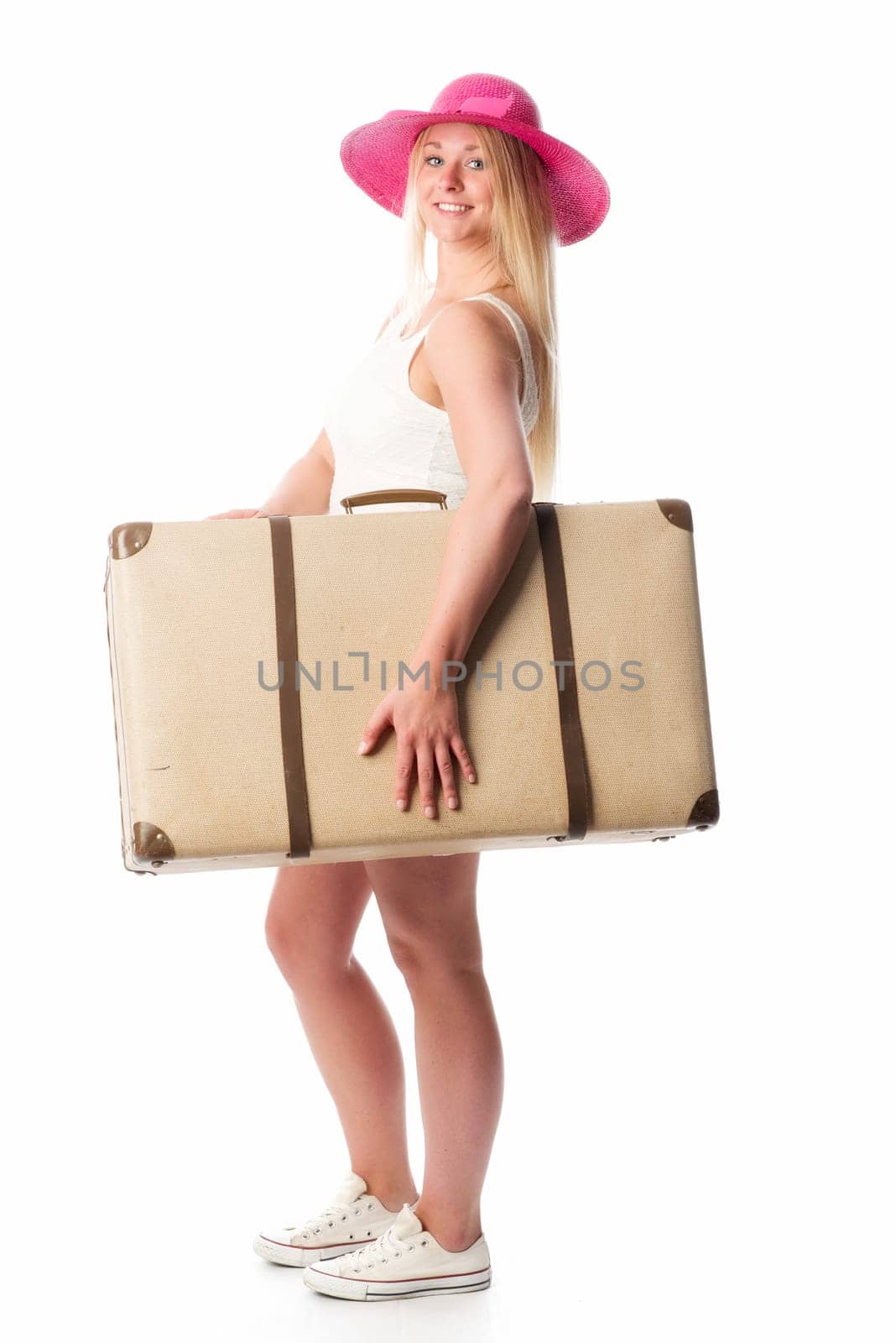 Girl with straw hat carries a suitcase