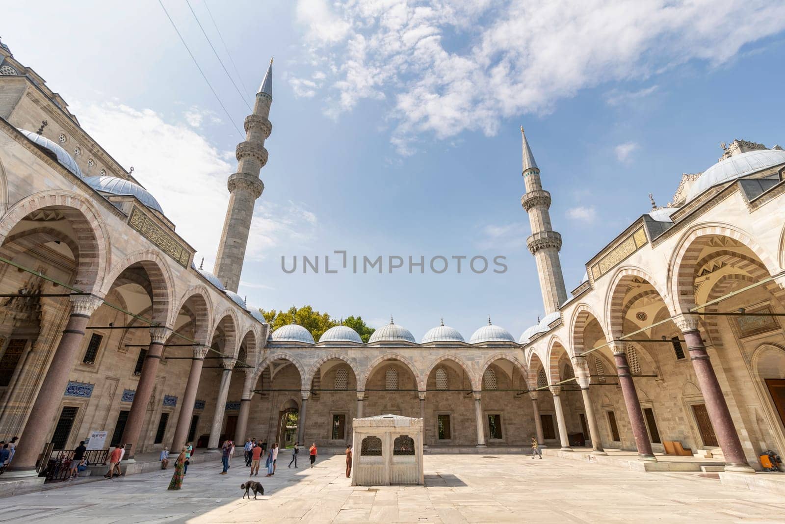 Istanbul, Turkey - August 26, 2022: Suleymaniye Mosque with few tourists visiting the place, an Ottoman imperial mosque located on the Third Hill of Istanbul, and the second largest mosque in the city